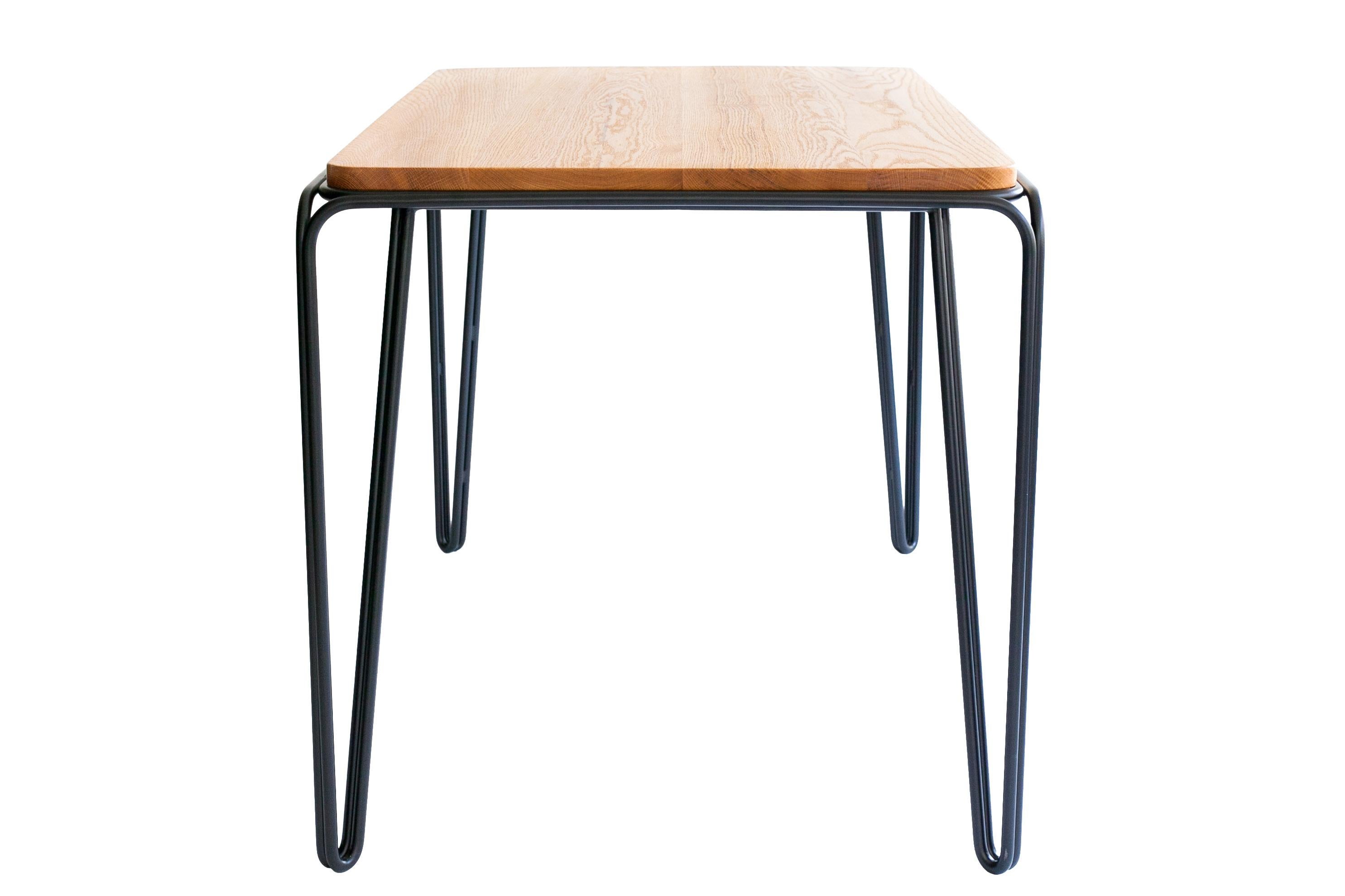 The Wired table features a minimal double wire bent steel frame that support a shaped solid wood top.
The design simplicity is highlighted by angular steel lines and its un-obstructing steel frame.
The Wired table works in small and larges spaces.