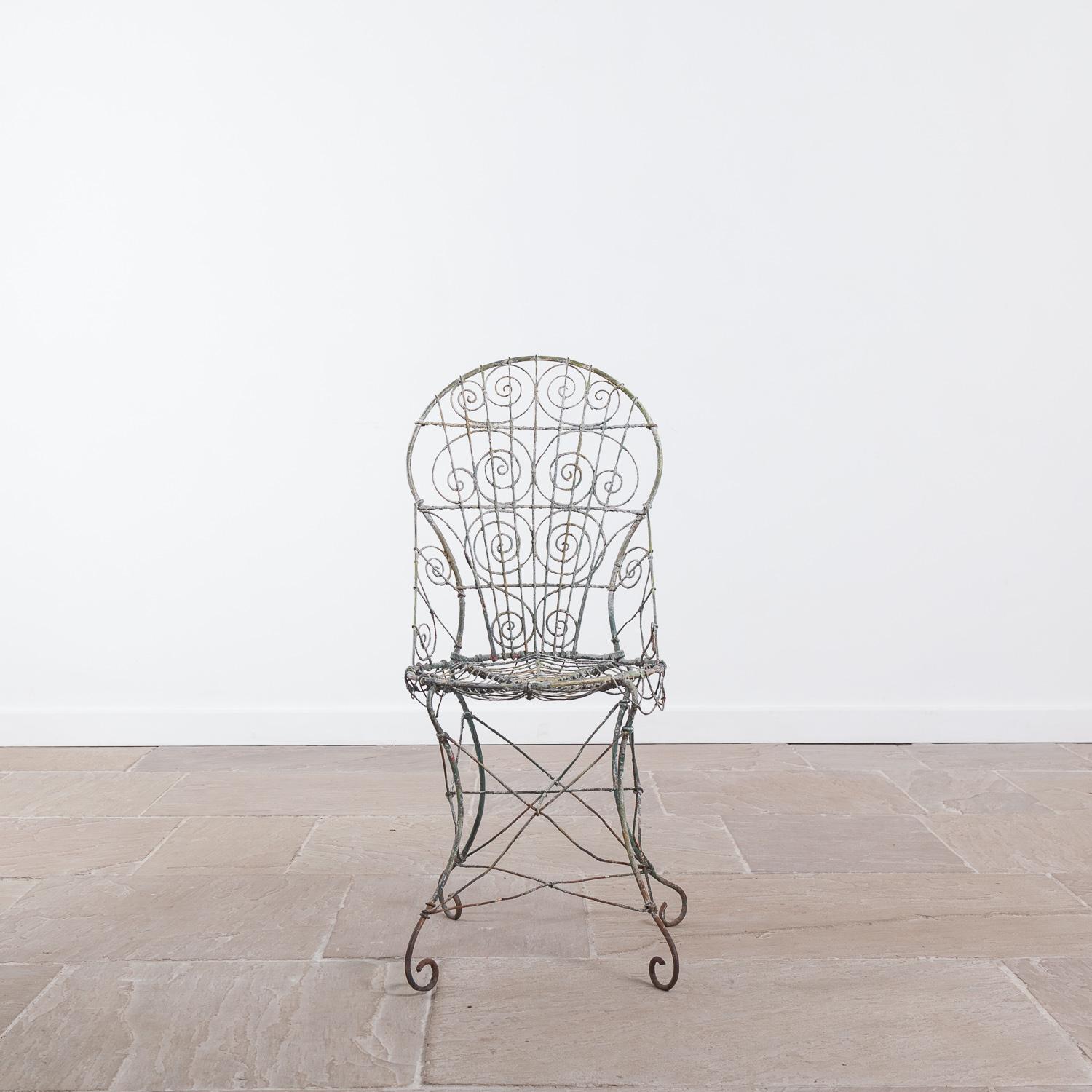 Wirework garden chair, circa 1820. The chair has been painted many times throughout its lifetime, leaving an attractive paint effect.

Measures: Height 93 cm x width 40 cm x depth 48 cm.