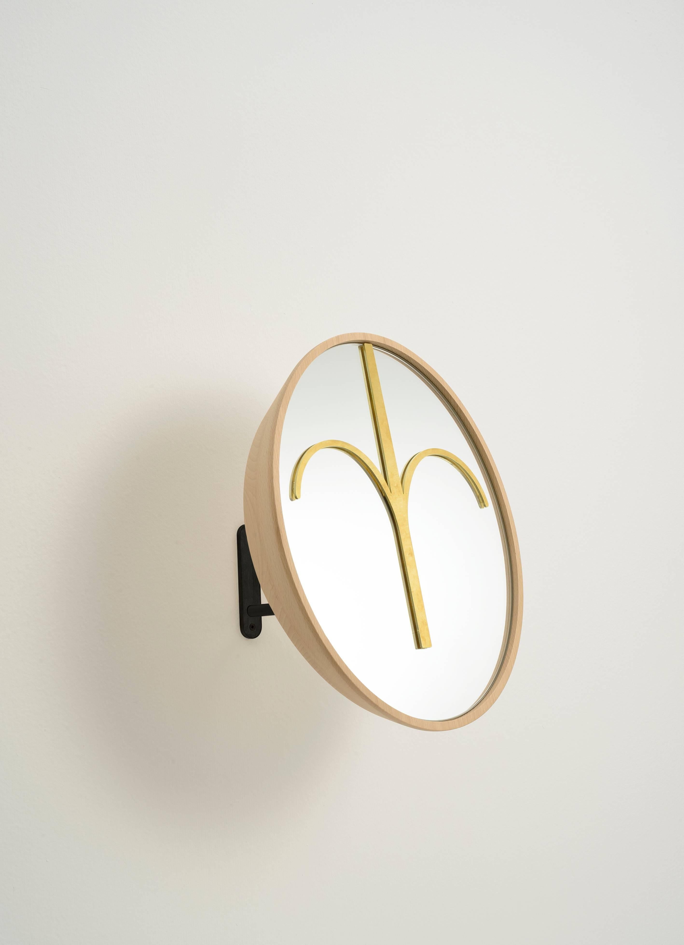 A functional mirror for a dressing room, or wooden masks and sculpture for your living or your entrance. The rounded mask Haua is made of natural beech wood, with a brass element on the mirror. The base is an iron stand black lacquered, but upon