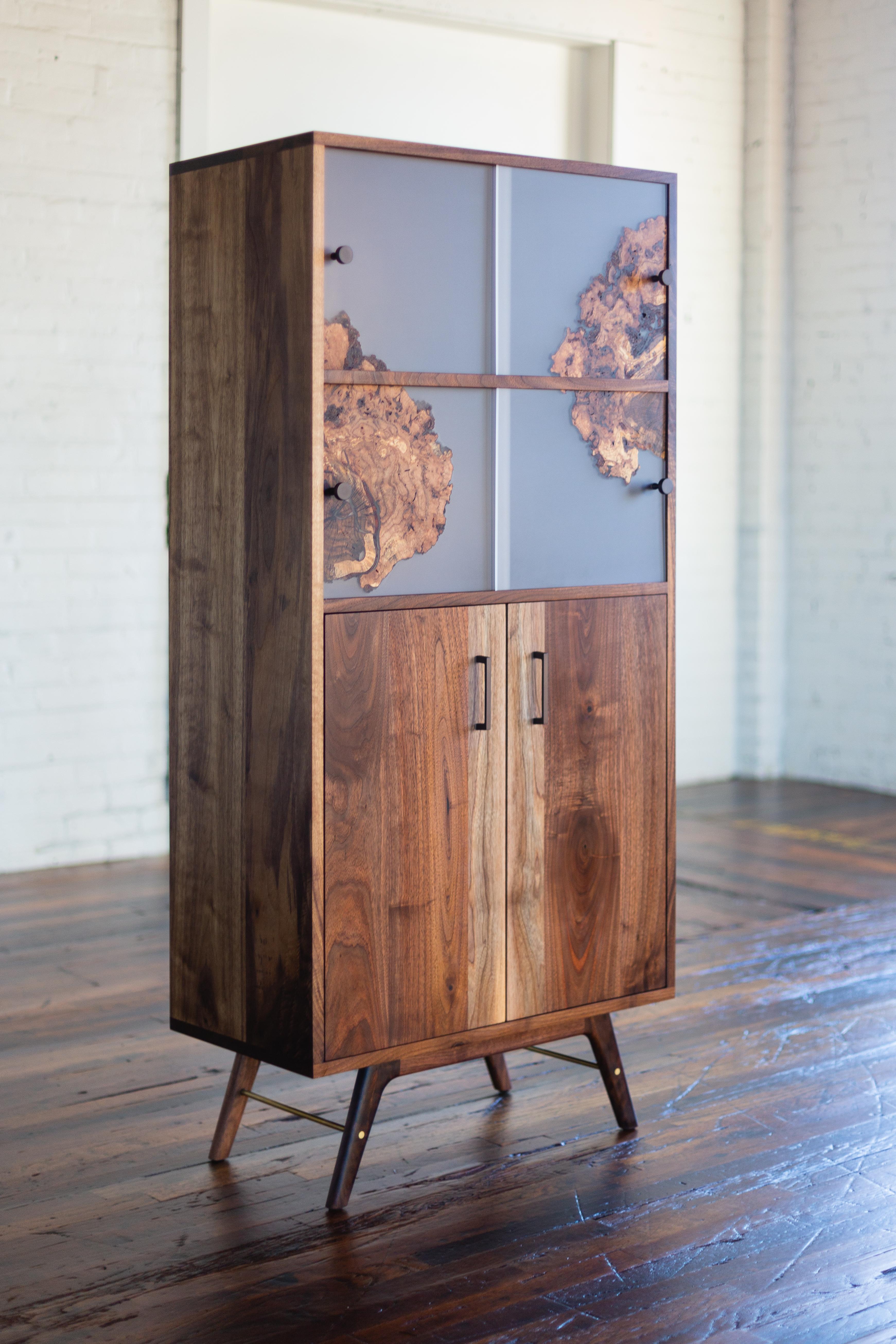 A modern cabinet with custom sliding panels and inset cabinet doors. Simple geometric lines and proportions accented by subtle curves in legs. The white sapwood of black walnut is used to give a rhythm to the cabinet.
The panels are poured with