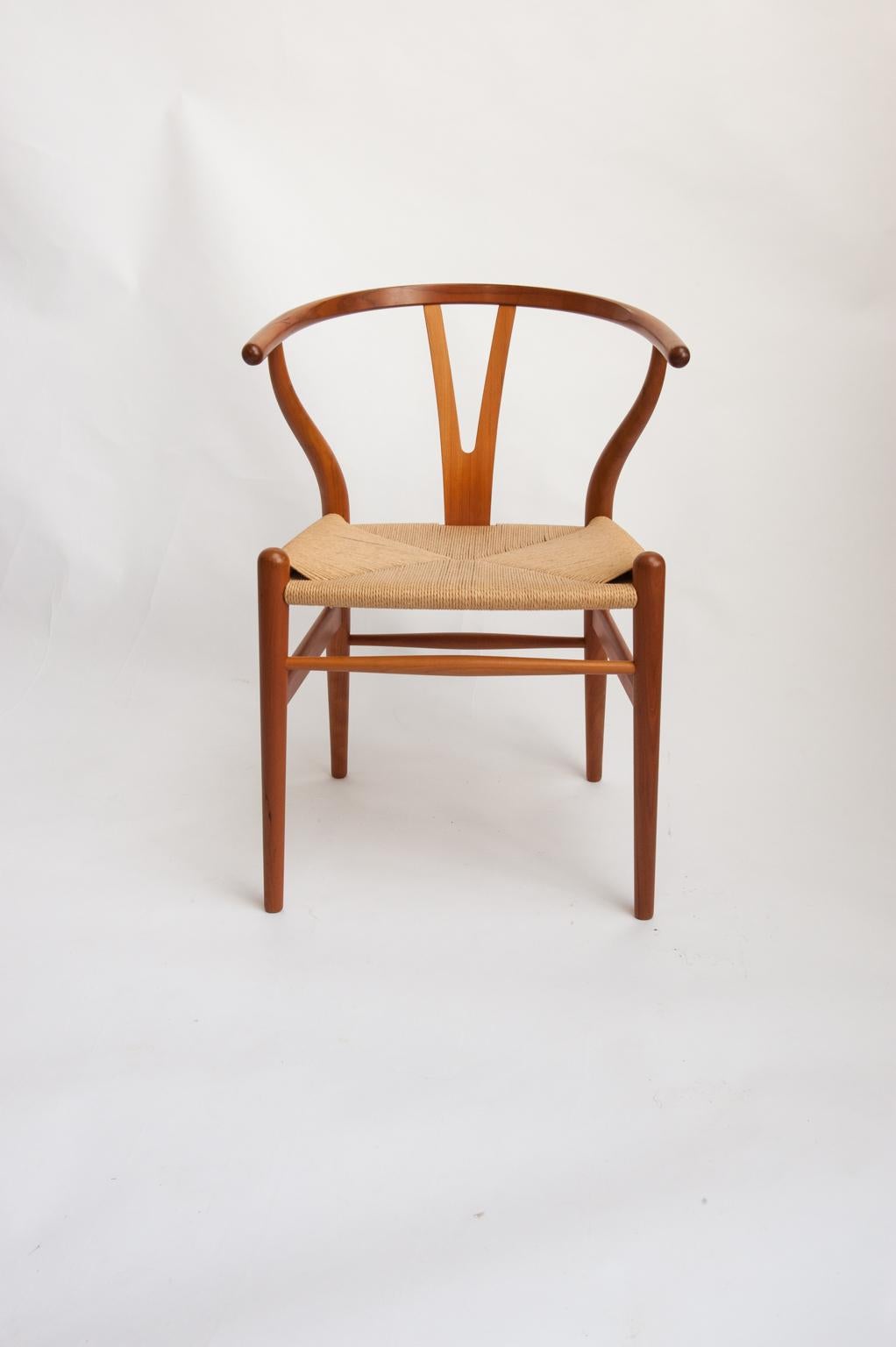 The beautiful Y-Chair or Wishbone chair, model CH 24, was designed in 1950, and has become Wegners best selling chair. The chair has its roots in the orient, and is light and elegant with very good sitting comfort. 
This close to perfect set of