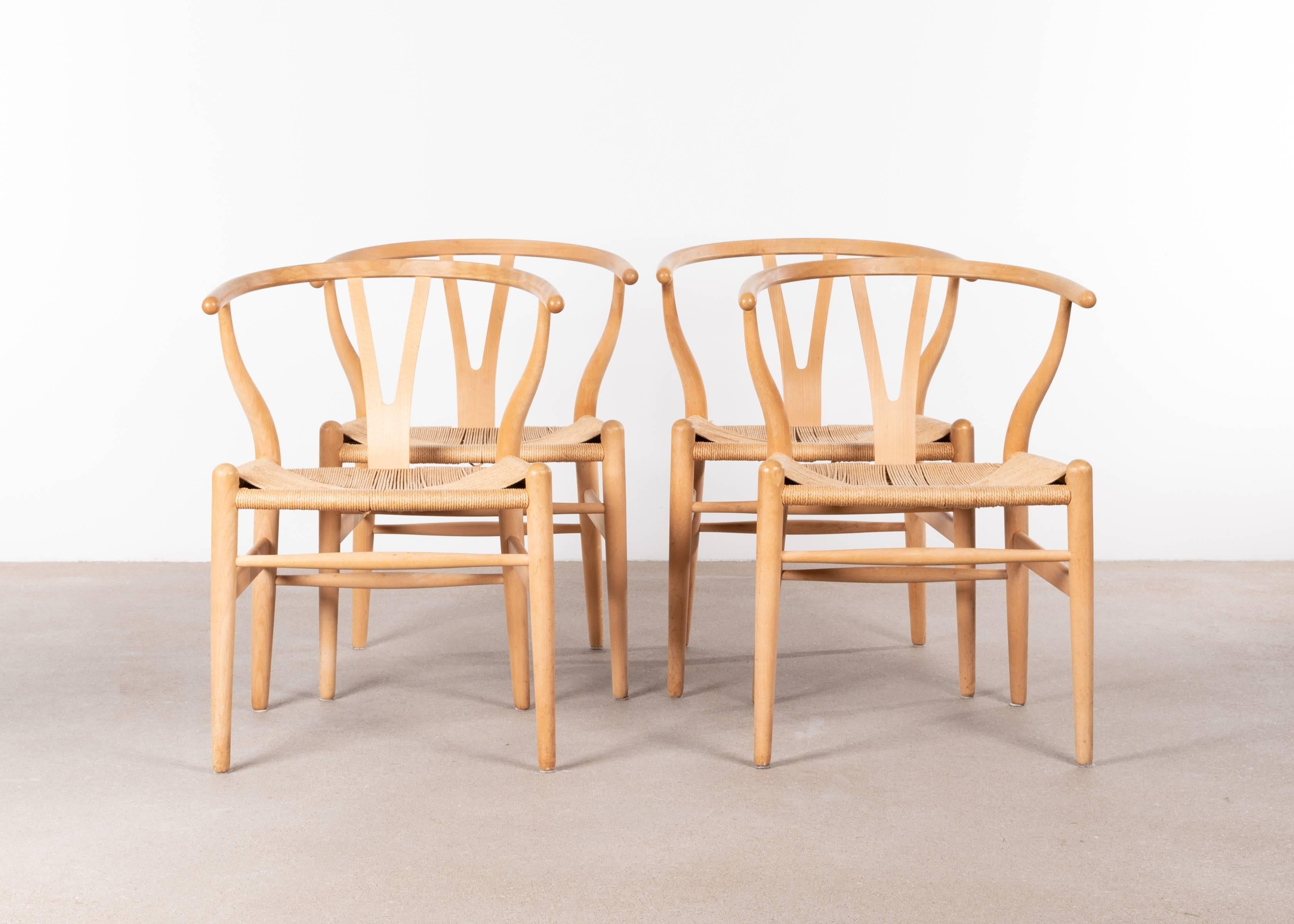 Nice set of Wishbone chairs (model CH24) in light wood by by Hans Wagner for Carl Hansen & Søn. Very good condition with solid frames and no damage to the papercord. All chairs are signed with manufacturer label.