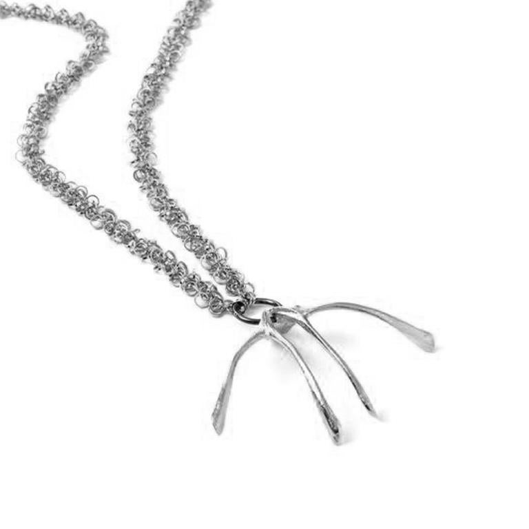 Designed by Alexandra Koumba this wishbone pendant is casted from the original chicken bone and embellished with a lavish chain to be a timeless accessory. Two bones in one chain is symbolic of feng shui's ideal to pair things to attract