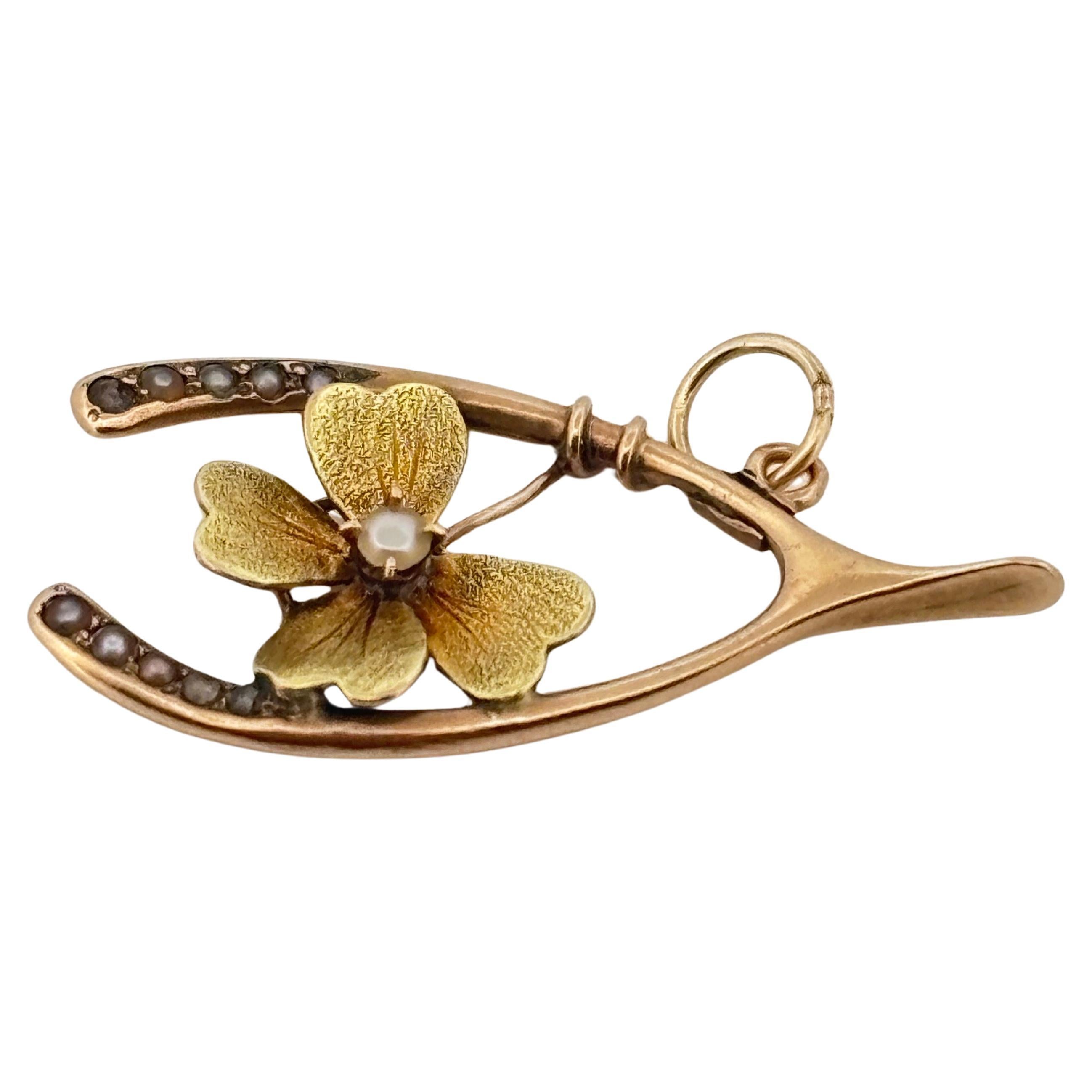 This charming antique pendant embodies both sentiment and elegance, beautifully crafted in 14k yellow gold. Designed in the form of a wishbone—a timeless symbol of luck—it measures approximately 1.25 inches long by 0.5 inches wide and weighs 1.4