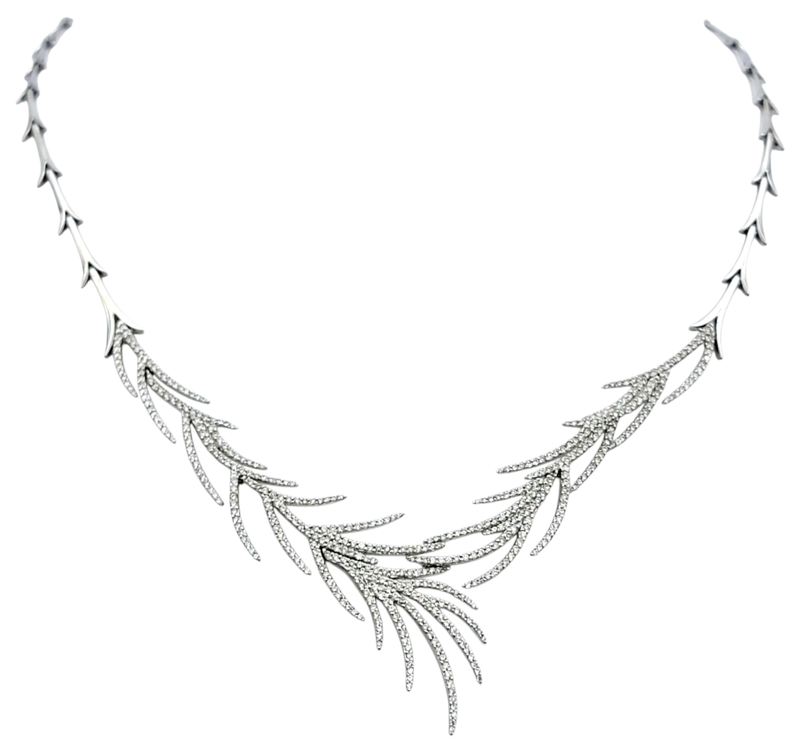 This elegant necklace features a flowing foliage-inspired design that captures the natural grace of leaves in motion. Crafted in 14 karat white gold, it shimmers with hundreds of round brilliant-cut diamonds that gracefully trace the curves of each