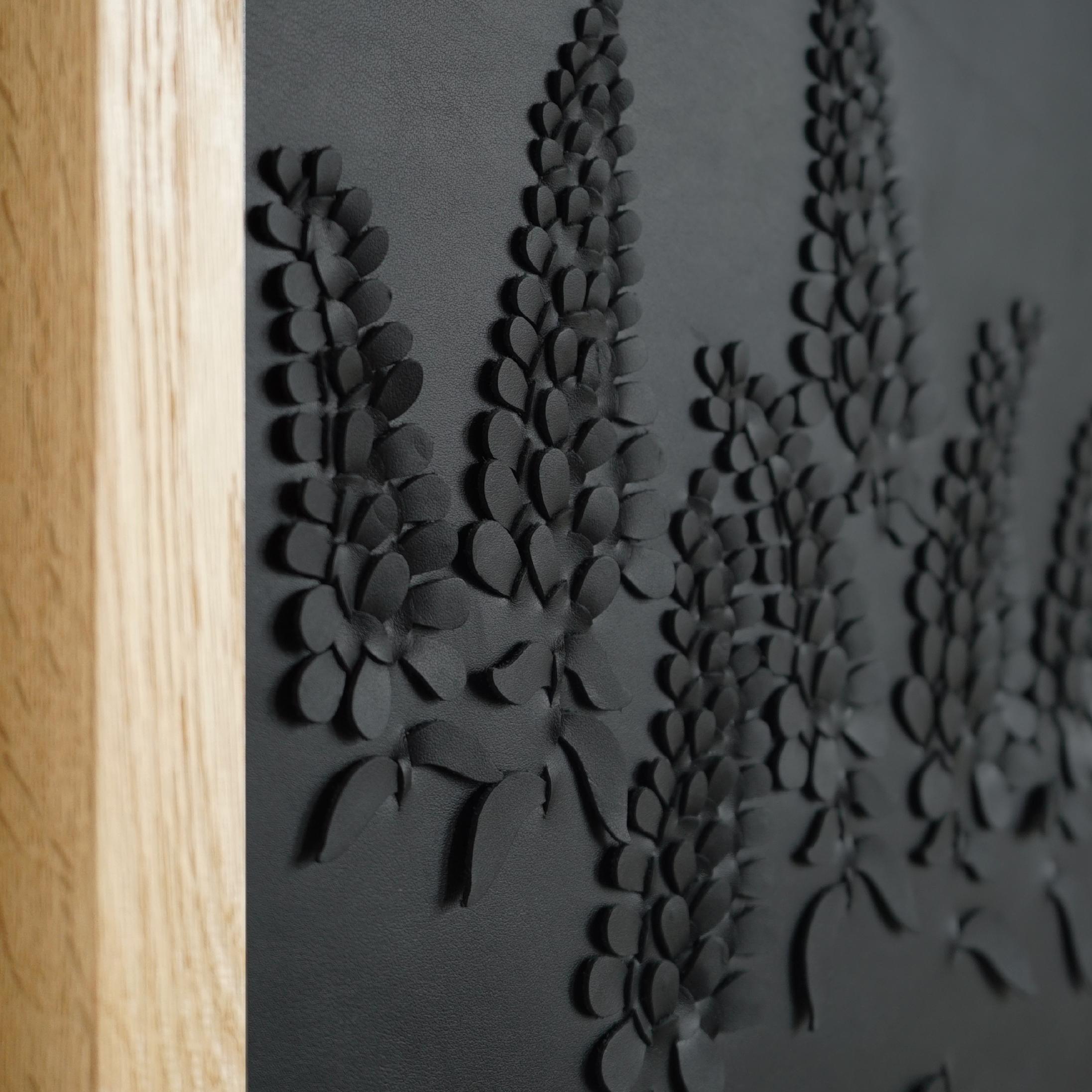 Wisteria:

A piece of 3D sculptural wall art designed and made from two layers of black leather woven together by Louise Heighes.
Measurements are 17 x 17 inches or 43 x 43 cm

This piece is inspired by the lovely change in scale that occurs in a