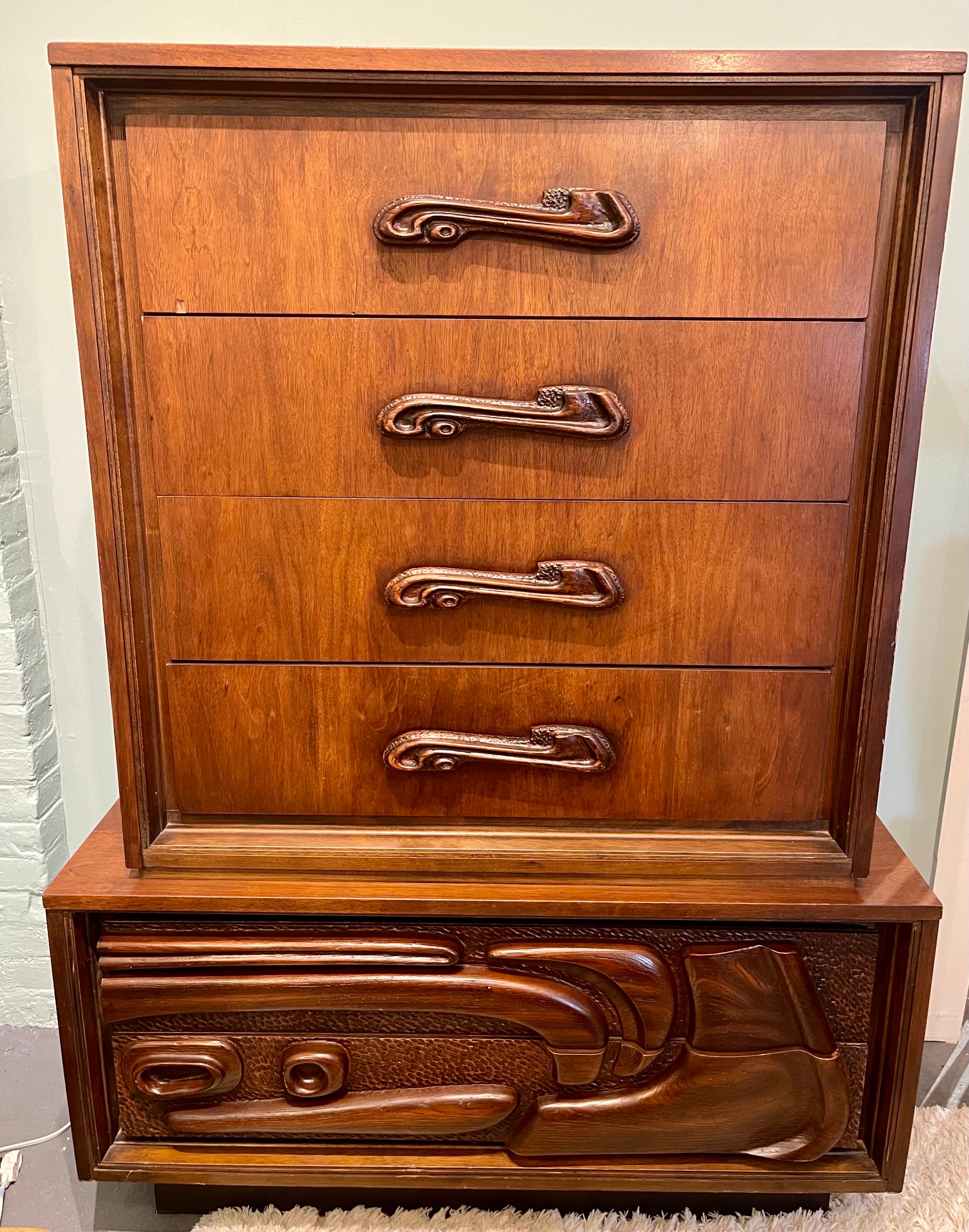 Crafted with meticulous attention to detail, this Pulaski Oceanic Brutalist Gentleman's Chest dresser features a commanding presence with its unique pedestal base and six spacious drawers. The Oceanic-inspired carved facade creates a mesmerizing