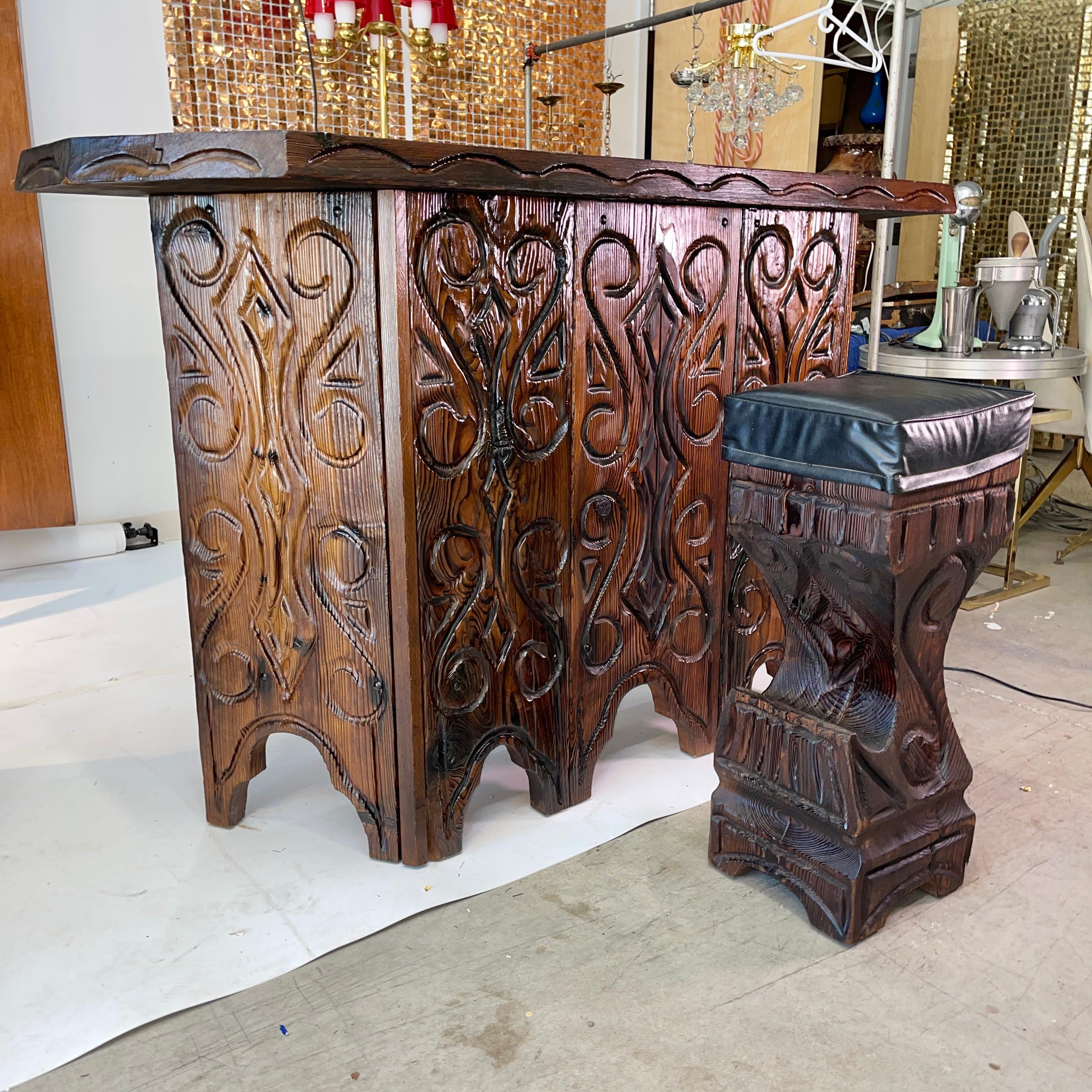 Original Witco Hacienda bar (model X265) and THREE stools (model K-55B) by William Westenhaver. Hand and chainsaw carved. No two are identical. Indulge in some cultural appropriation and add this Mid-Century Modern Polynesian Tiki flavor to your