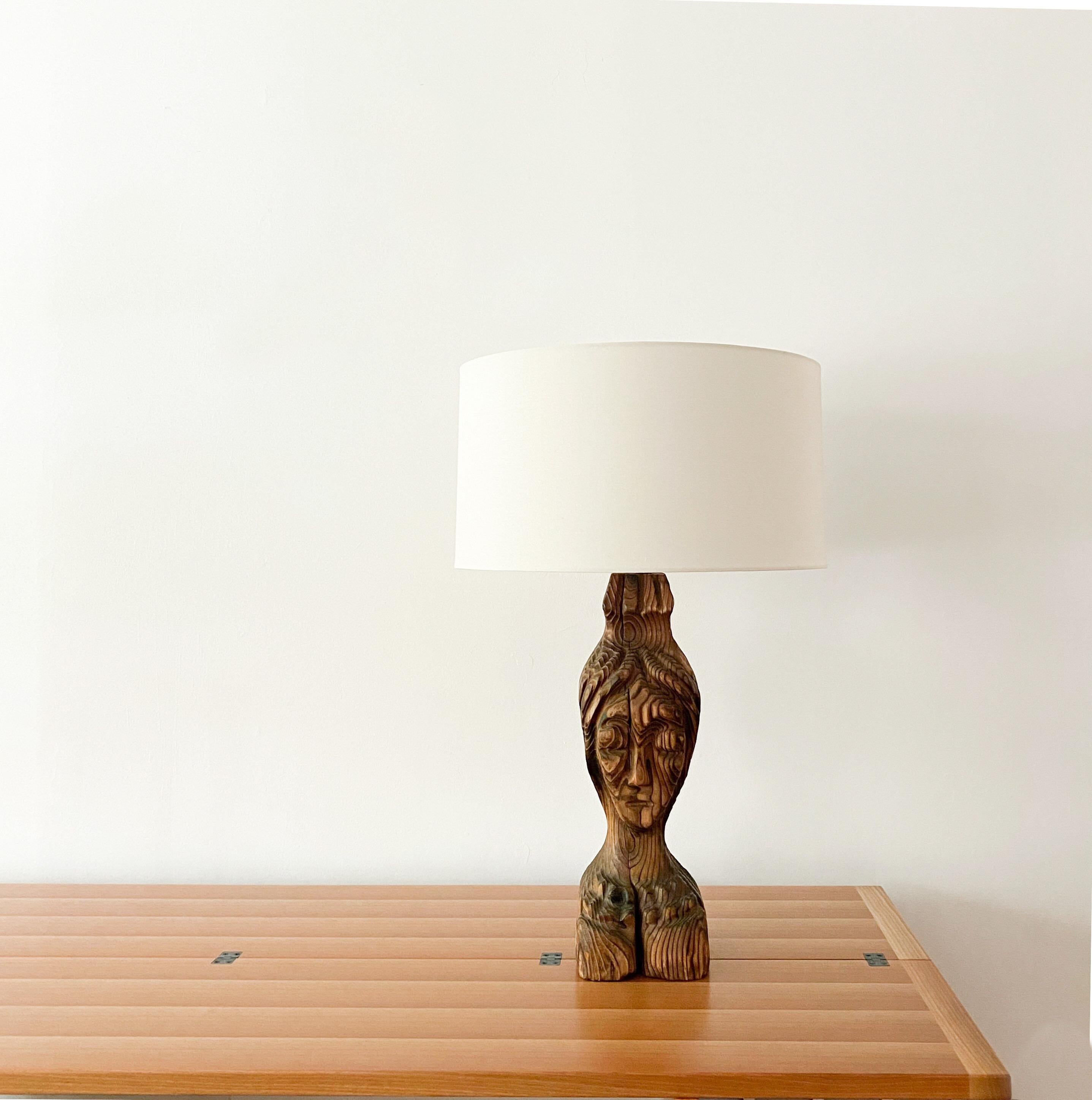 A hand carved sculptural wood lamp manufactured by Witco is from the Mid-20th Century. The imposing lamp has been retrofitted using new electical hardware with a nickel finish, new wrapped gray nylon cording and a new retro plug. The lamp is not