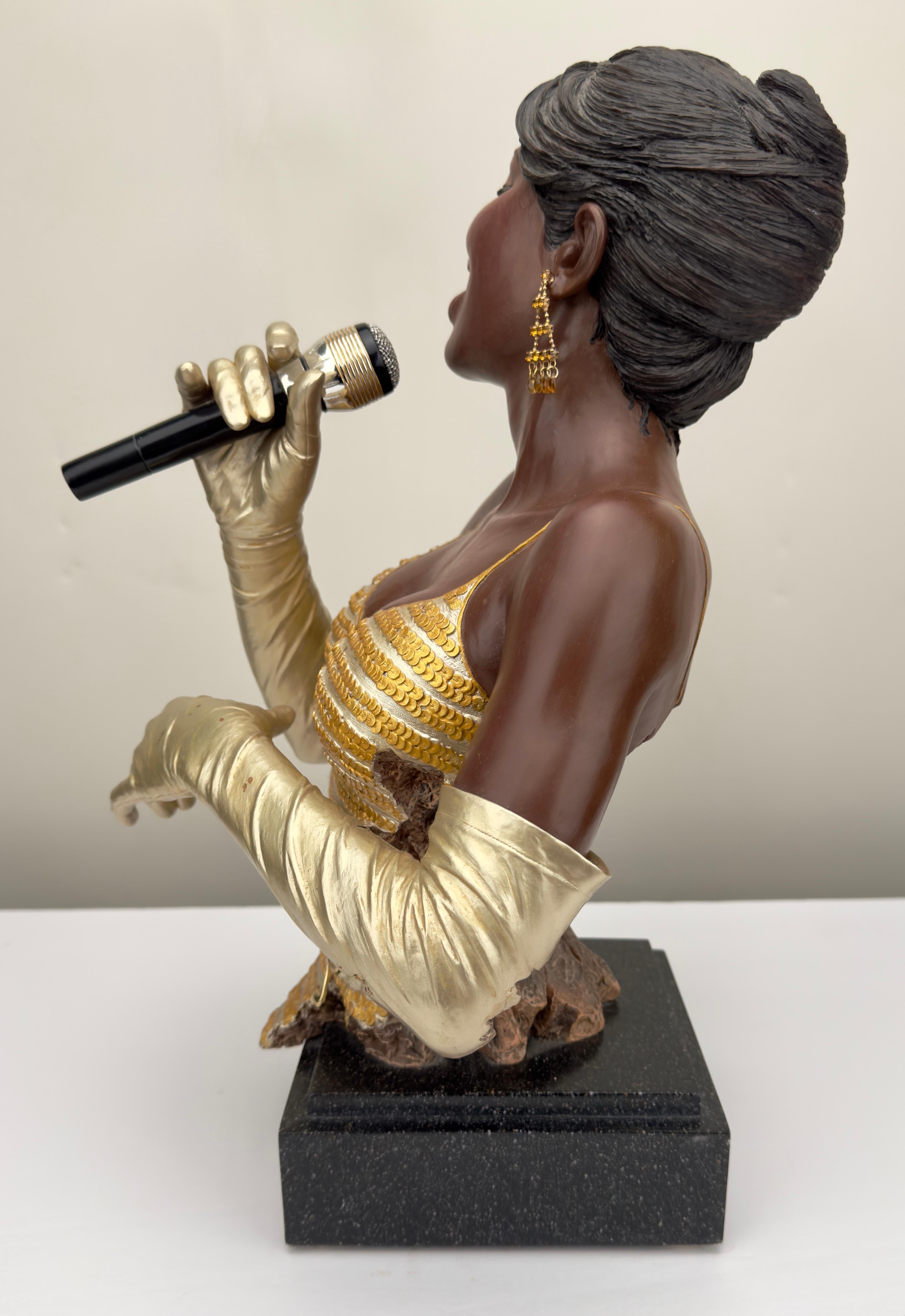 An impressive lady in gold jazz singer sculpture by Willitts Designs International and Shen Lung. The sculpture is cold painted and made of hand cast resin. The singer is wearing gold gloves, gold dress and gold earrings. The art piece is standing