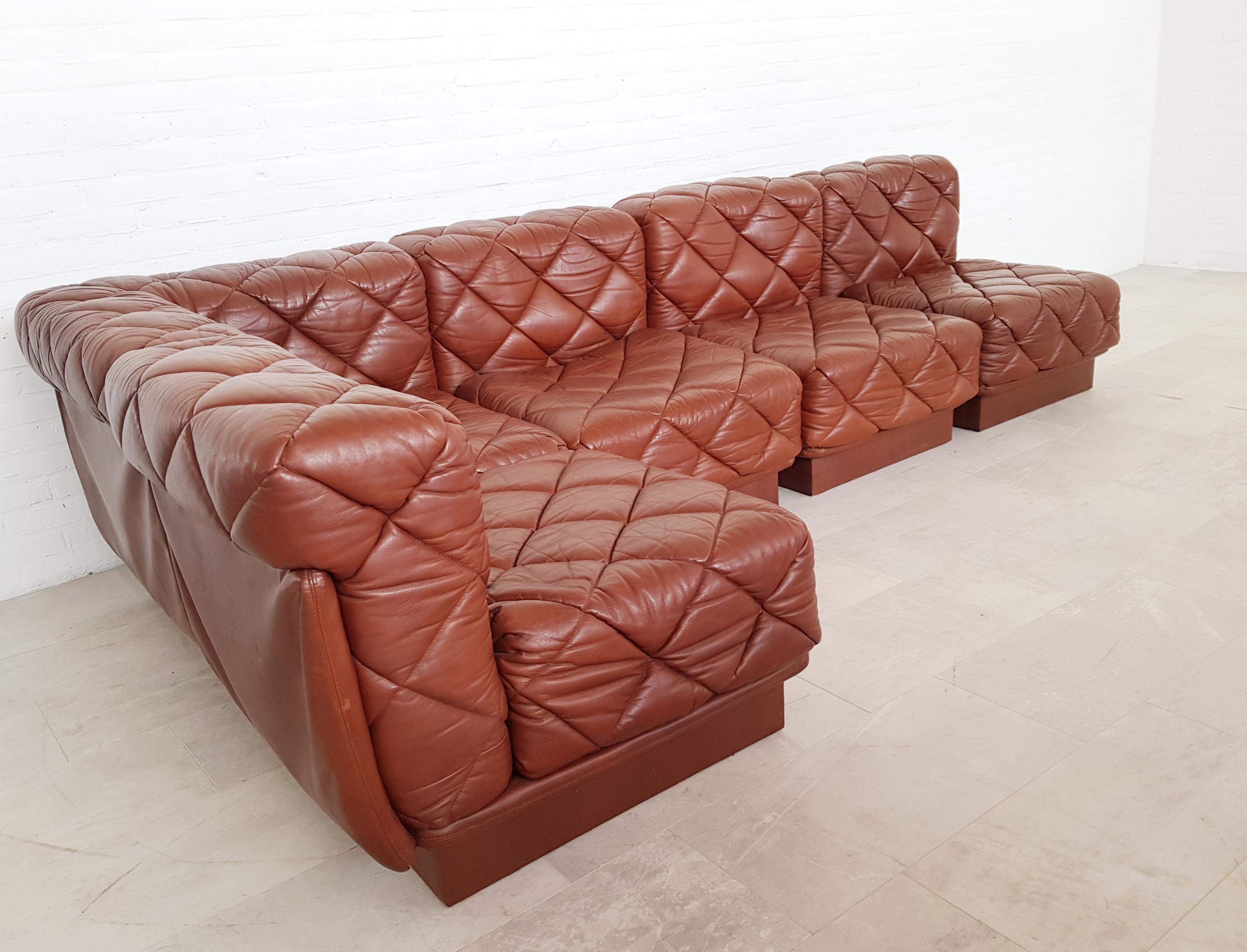 Modular sofa model ‘Rhombos’ designed by Karl Wittmann in 1973, manufactured by Wittmann Möbelwerkstätten, Austria.
Edited in a beautiful dark cognac colored high quality leather with quilted stitching. The elements can be arranged freely or suited