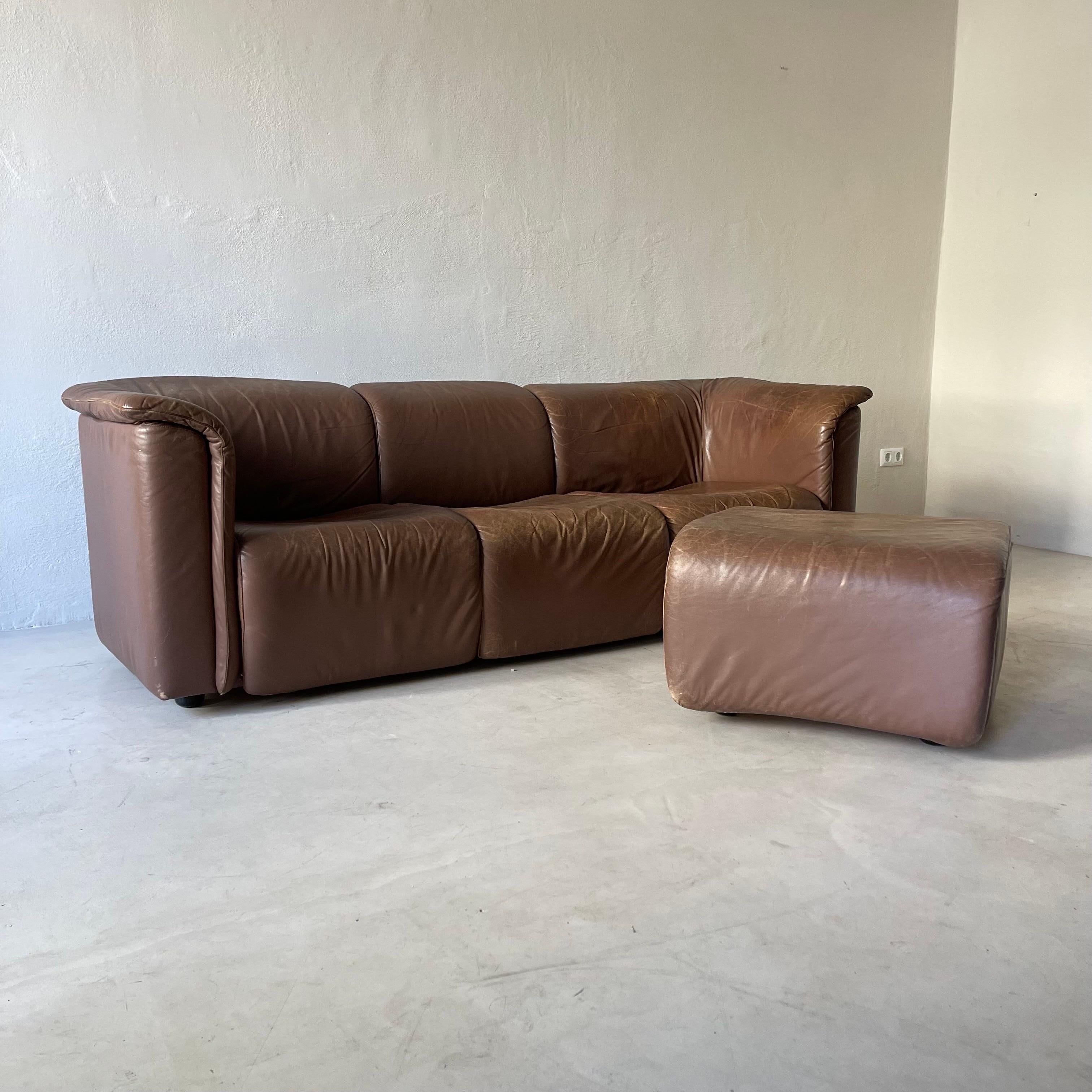 Hochbarett sofa designed by Karl Wittmann and manufactured by Wittmann Moebelwerkstaetten, reknown for their exceptional quality and craftsmanship. This is a splendid set of two, with a three seater sofa and one additional ottoman.