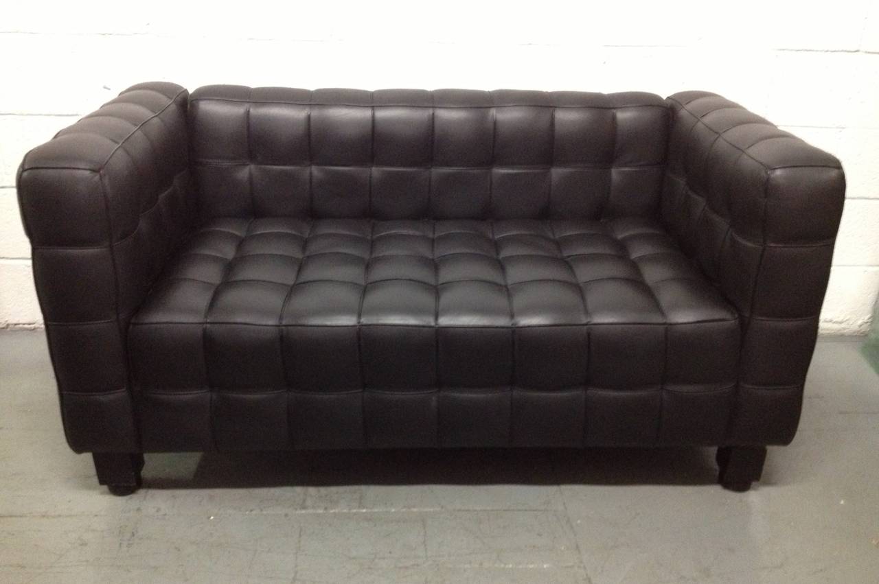 Black leather tufted loveseat or sofa designed by Josef Hoffmann (1870-1956). Sofa is tufted all the way around. Quality leather. Has black painted wood legs. Wittmann Kubus sofa designed in 1910.