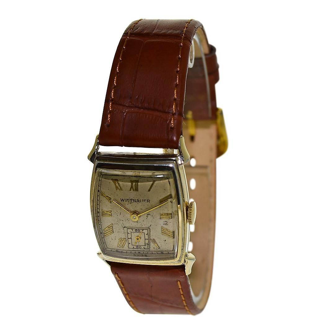 FACTORY / HOUSE: Wittnauer Watch Company
STYLE / REFERENCE: Tortue Shape 
METAL / MATERIAL: 14Kt. Yellow Gold Filled 
CIRCA: 1940's
DIMENSIONS: 33mm X 23mm
MOVEMENT / CALIBER: Manual Winding / 15 Jewels 
DIAL / HANDS:  Original Patinated Dial /