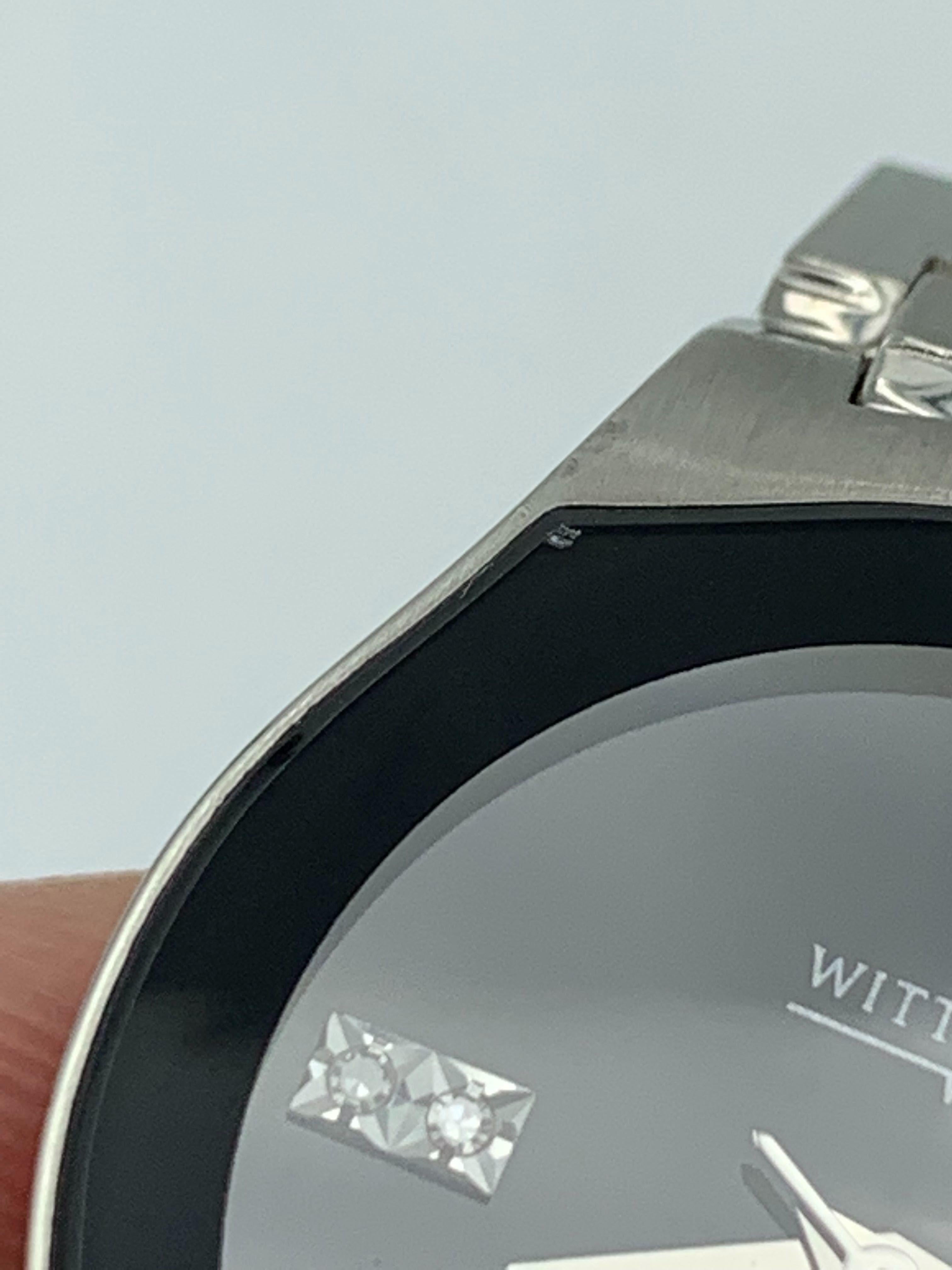 This New With Defects Wittnauer  10P02 is a beautiful Ladies timepiece that is powered by a quartz movement which is cased in a stainless steel case. It has a round shape face,  dial and has hand unspecified style markers. It is completed with a 