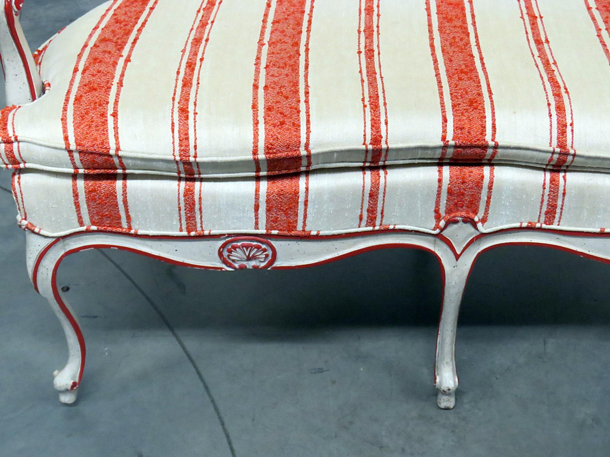 W&J Sloane Louis XV style settee with a distressed painted finish and a caned back.