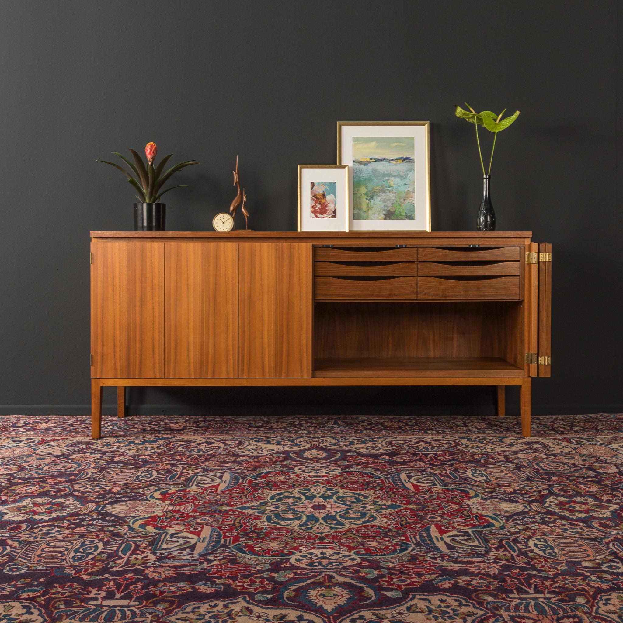 Very rare sideboard from the 1950s by Paul McCobb for WK Möbel. Corpus in walnut veneer with six internal drawers, two folding doors and straight feet.

Quality Features:
- Very high-quality materials
- Good workmanship
- Solid wood drawers
-