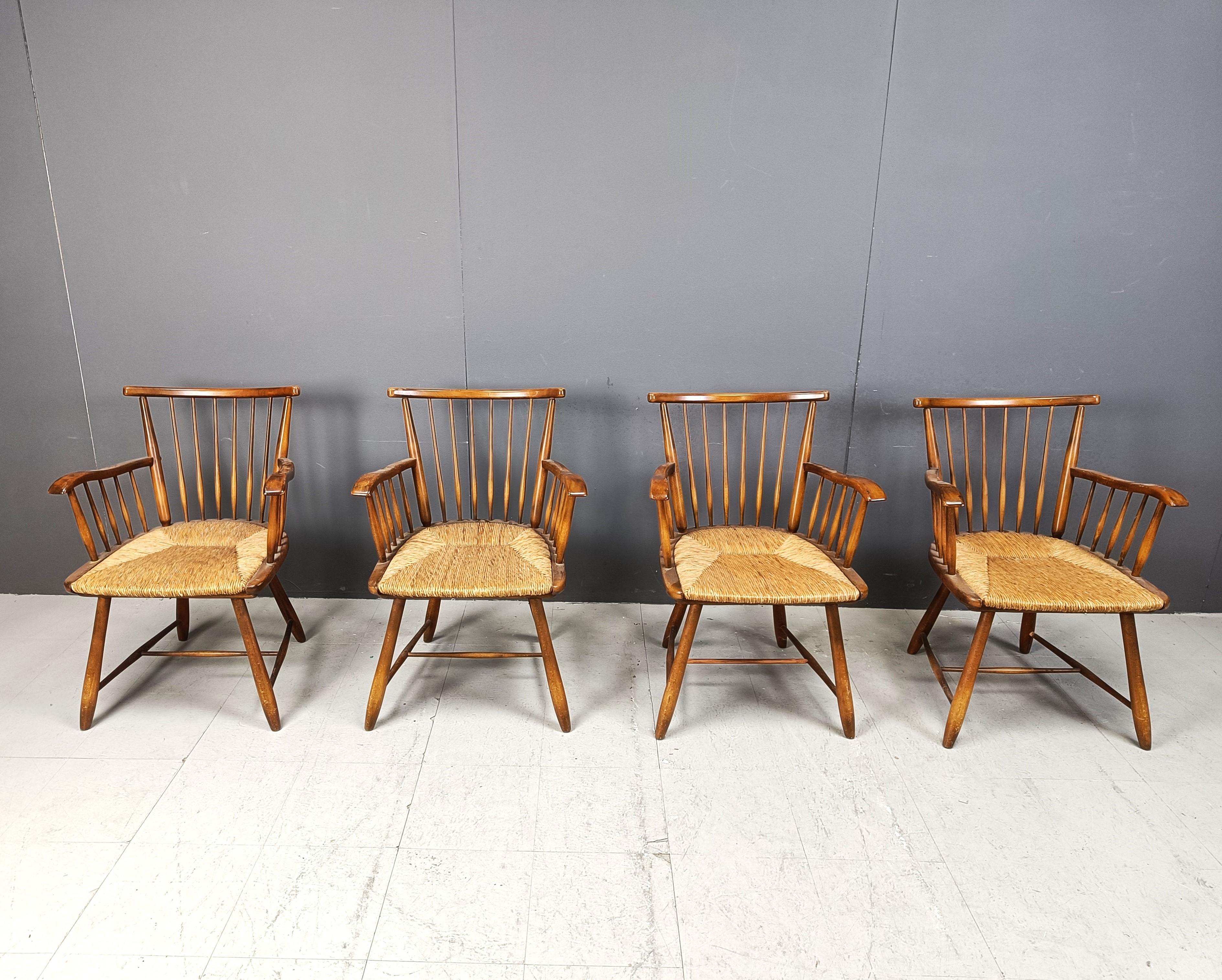 These high-quality armchairs were designed by Arno Lambrecht, who created several designs for WK Möbel in Germany during the 1950s. 

These elegant armchairs feature handwoven wickerwork seats made from rush and an elegant frame of solid