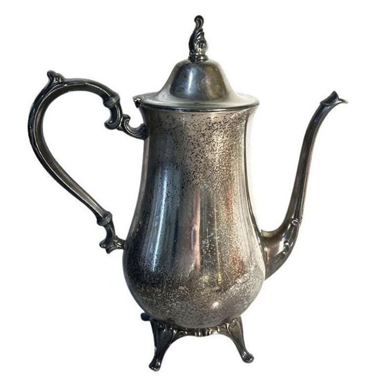 A tall silver plate coffee or tea server by WMA Rogers. A lovely piece for serving coffee or tea at your breakfast table. It features a stylized handle and spout and four intricately shaped legs. Marked at the bottom with WMA Rogers.
