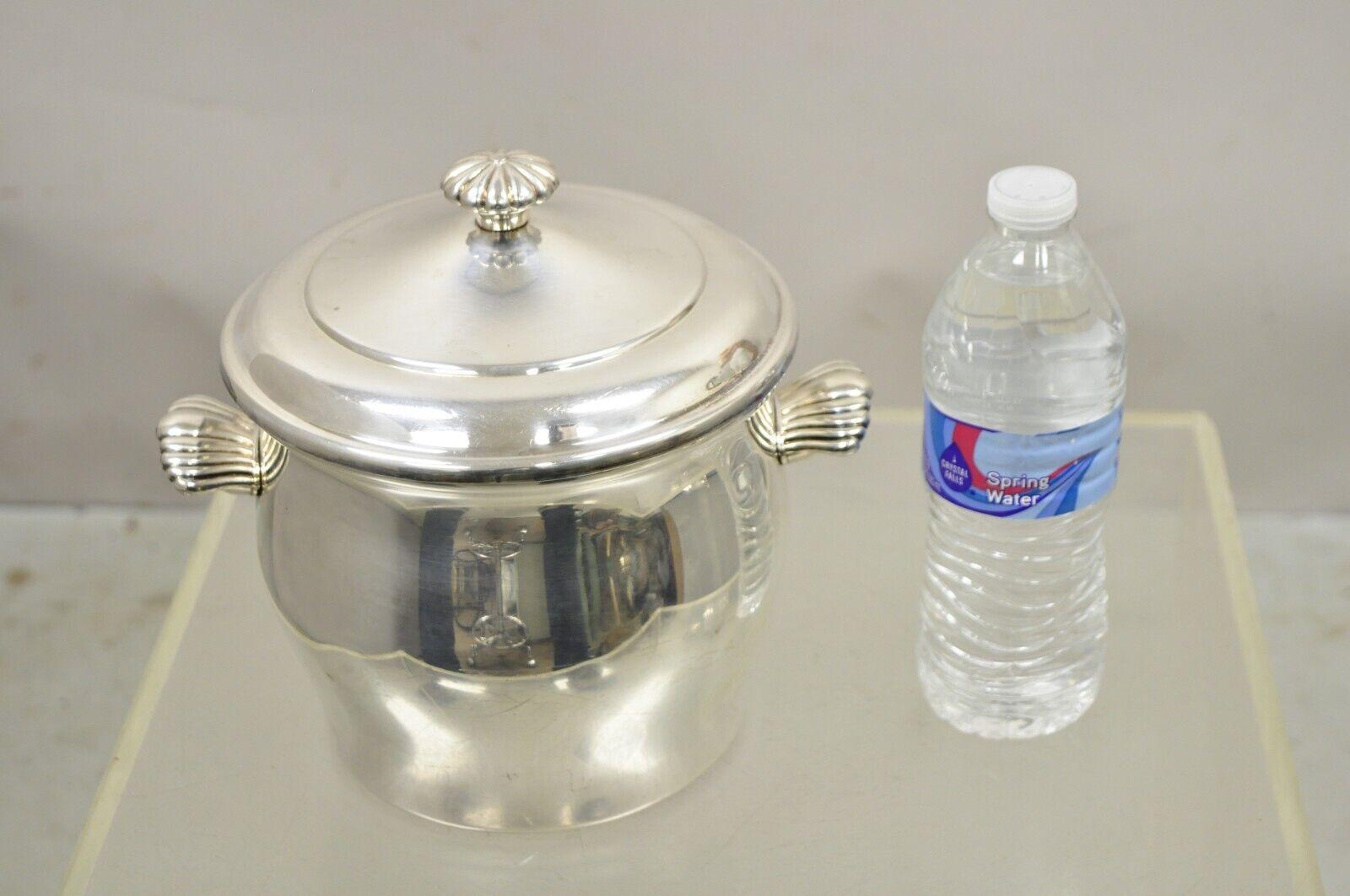 WM Rogers & Son Paul Revere 3027 Silver Plate Lidded Ice Bucket. Item features Leafy twin handles, glass liner, clean modernest lines, original hallmark. Circa Mid 20th Century. Measurements:  8