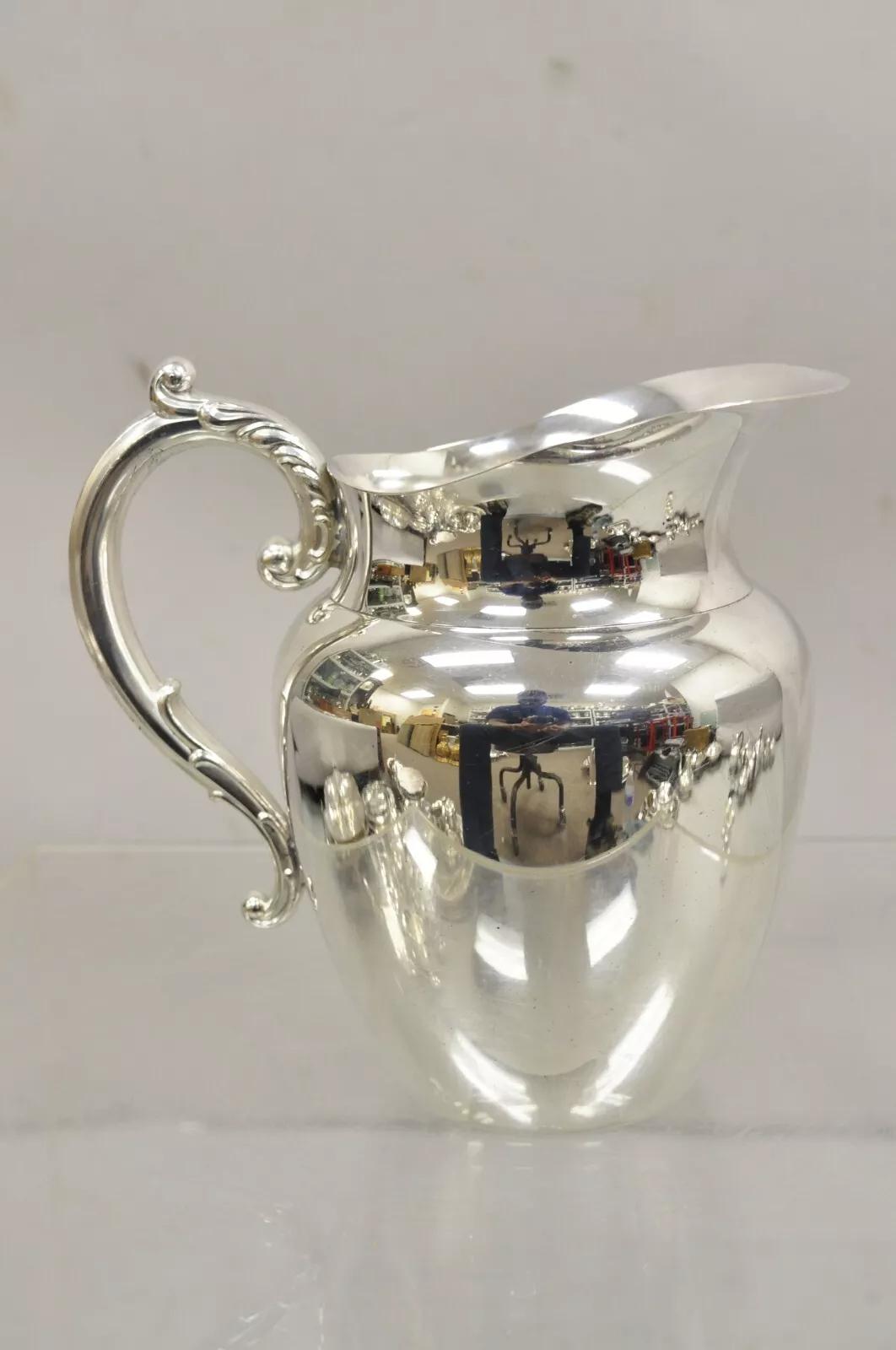 WMA Rogers Oneida Victorian Style Silver Plated Water Pitcher. Circa Late 20th Century. Measurements: 7.5