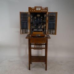 WMF. A 12-person cutlery service in original stylized secessionist oak cabinet