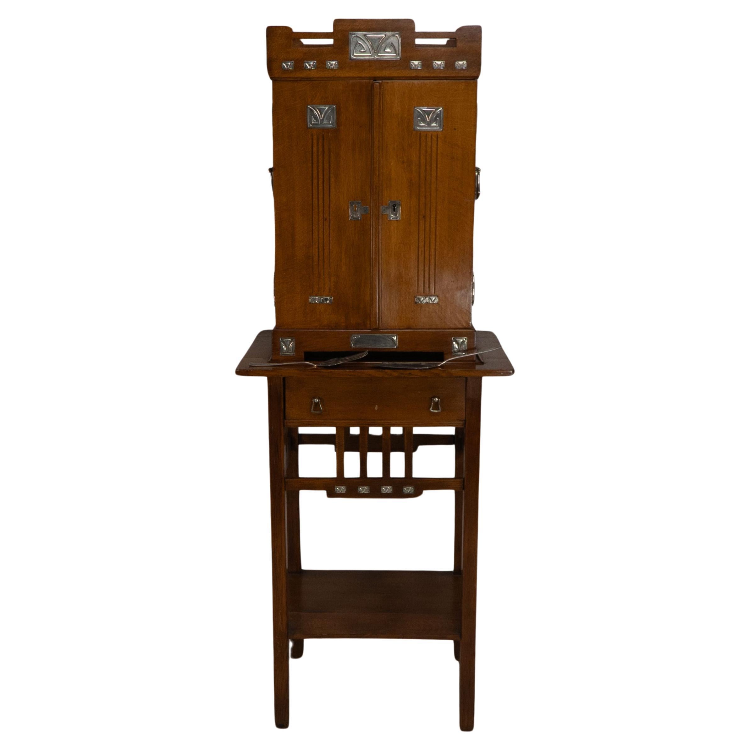 WMF. A 12-person cutlery service in original stylized secessionist oak cabinet