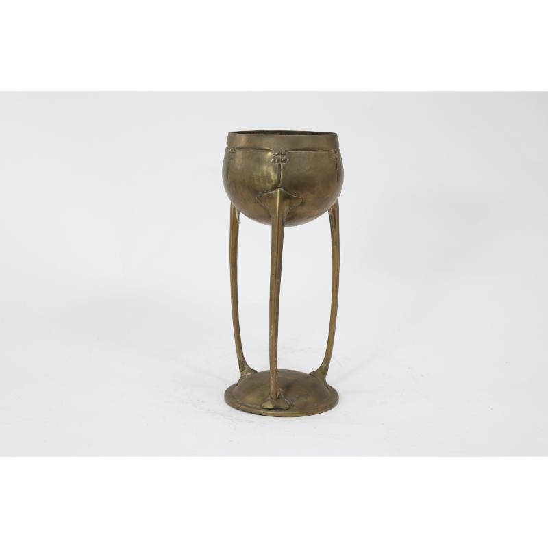 WMF. A hand beaten brass chalice, the bowl raised on three organic supports standing on a circular base. Originally silverplated.
