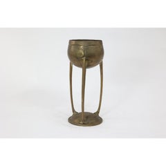 WMF. A hand beaten brass chalice, the bowl raised on three organic supports.