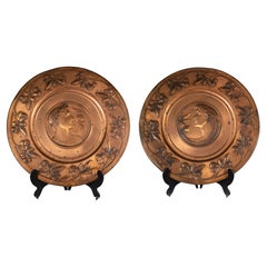 WMF. A pair of brass wall plaques embossed with a lady's and gentleman's heads