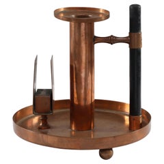 WMF. An Aesthetic Movement Copper Chamber Candlestick in the Dr C Dresser Style