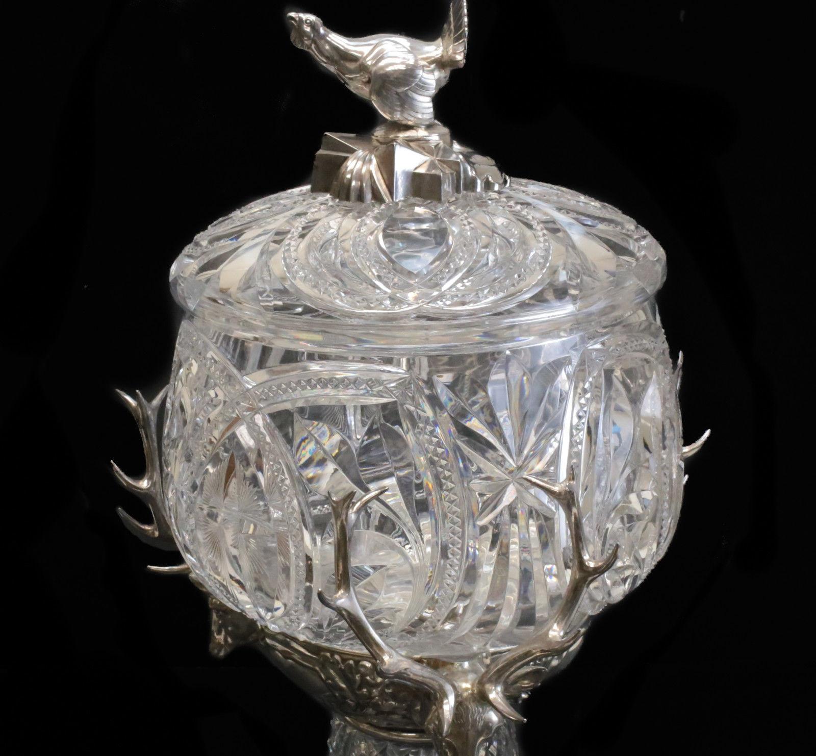 A magnificent WMF silver plate and brilliant cut glass lidded centerpiece bowl, circa 1910. Beautiful cut glass diamond and starburst designs throughout. 3 outstanding hand chased figural deer heads to the circular band and a figural chicken forming