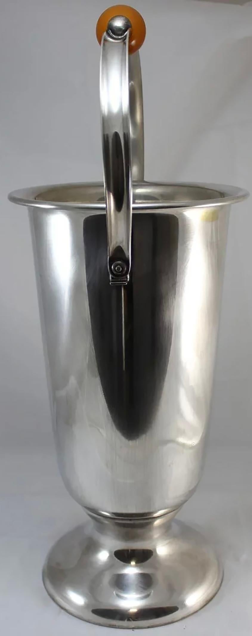 A fine Art Deco champagne cooler with butterscotch bakelite center knob, made by WMF (Württembergische Metallwarenfabrik) of Germany, with a WMF hallmark on the underside of the handle. Dates to the early to mid 20th century in very good condition,