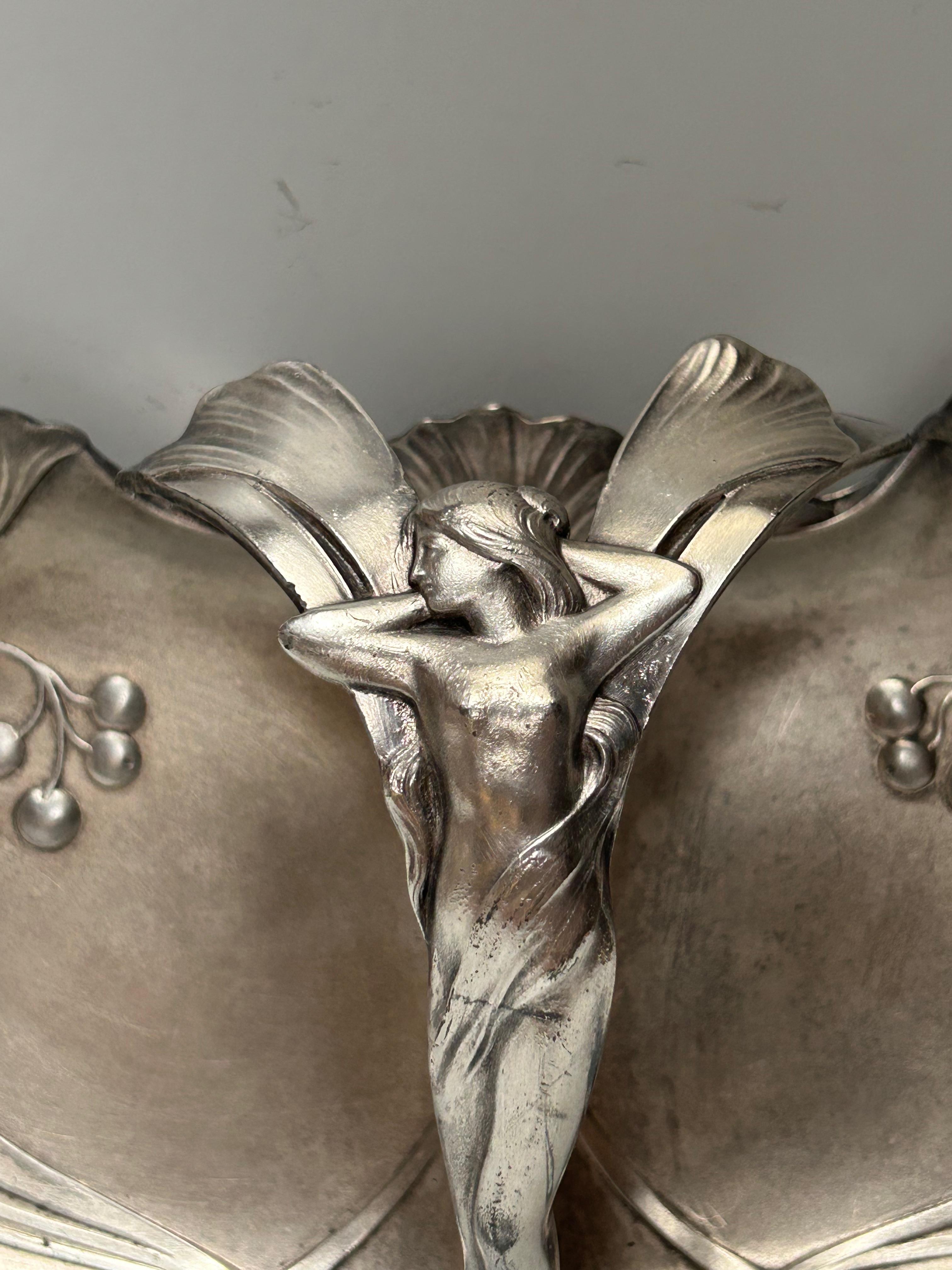 Art Nouveau aperitif server or pin tray, circa 1900.
Silver-plated metal with ginkgo biloba leaf decoration, handle decorated with a woman.
Stamped WMF.
In very good condition.

Total height: 9.5 cm
Width: 31.5 cm
Depth: 17 cm
Weight: 700 g

WMF was