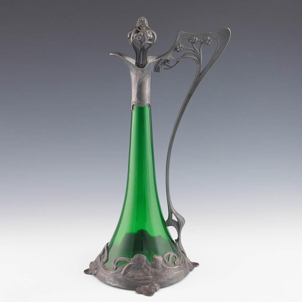 Heading : WMF art nouveau claret jug
Date : c1905 – has a WMF G ‘ostrich’ mark with a date range of 1903-10.
Origin : Gieslingen-an-der-Steige
Colour : Silver with green glass
Stopper : Pierced naturalistic Art Nouveau stopper
Body : Green glass.