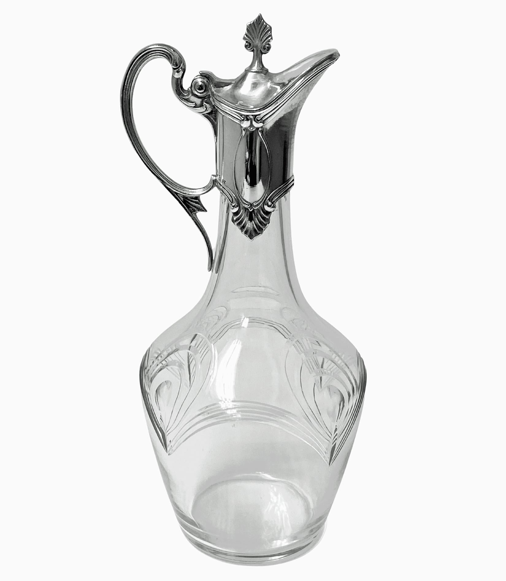WMF Art Nouveau cut glass and silver plate Liqueur Set C.1900. The silver plate set with liqueur jug and four glasses in holders, each with stylized art nouveau design engraved crystal. Height of Jug: 8 inches. Height of glasses: 1 7/8 - 2 1/8