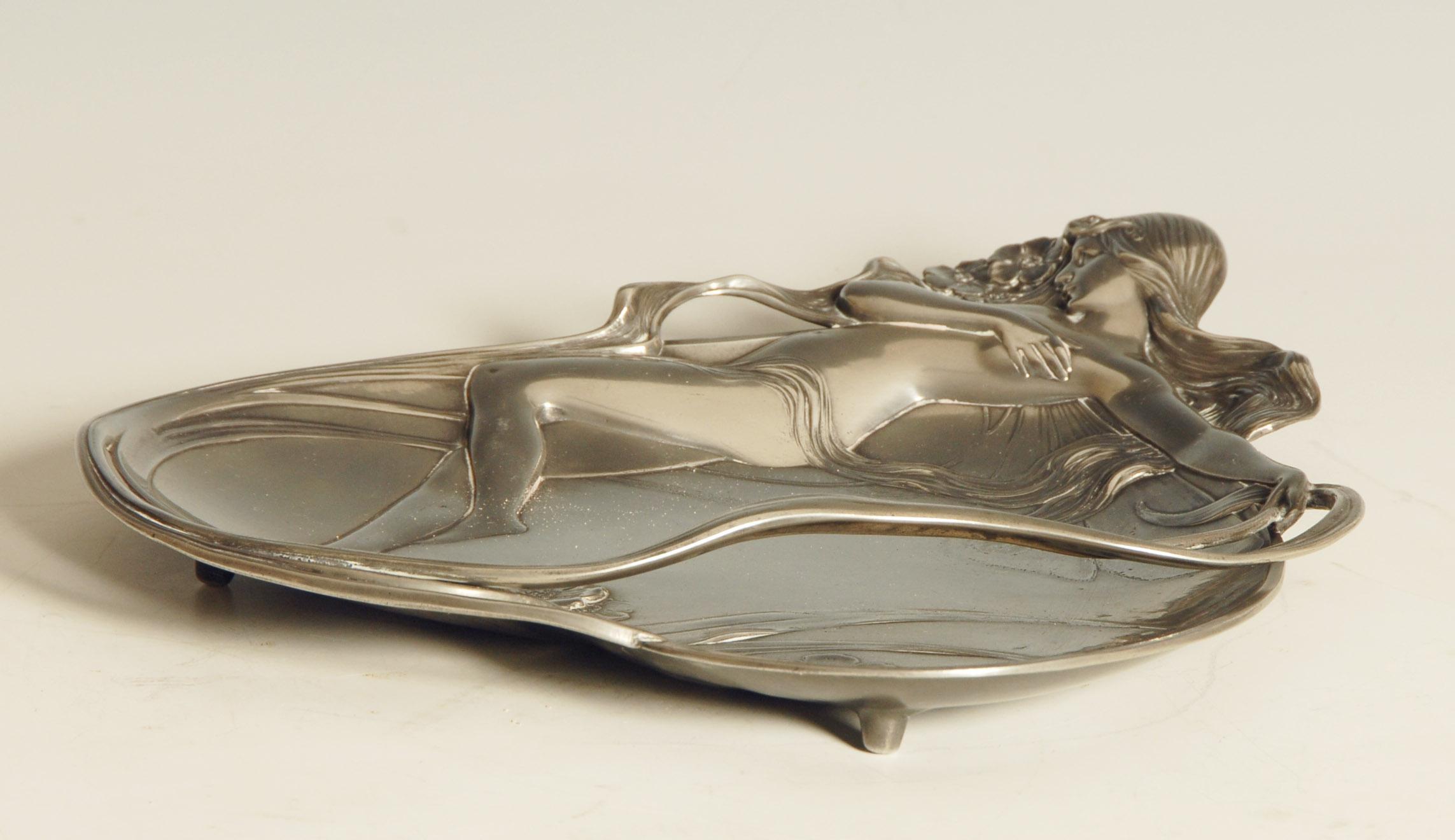 WMF Art Nouveau dish depicting a nude lady on a heart shaped leaf, circa 1900.

Plated pewter, manufacturers stamp, model number 232.

Price includes free shipping to anywhere in the world.