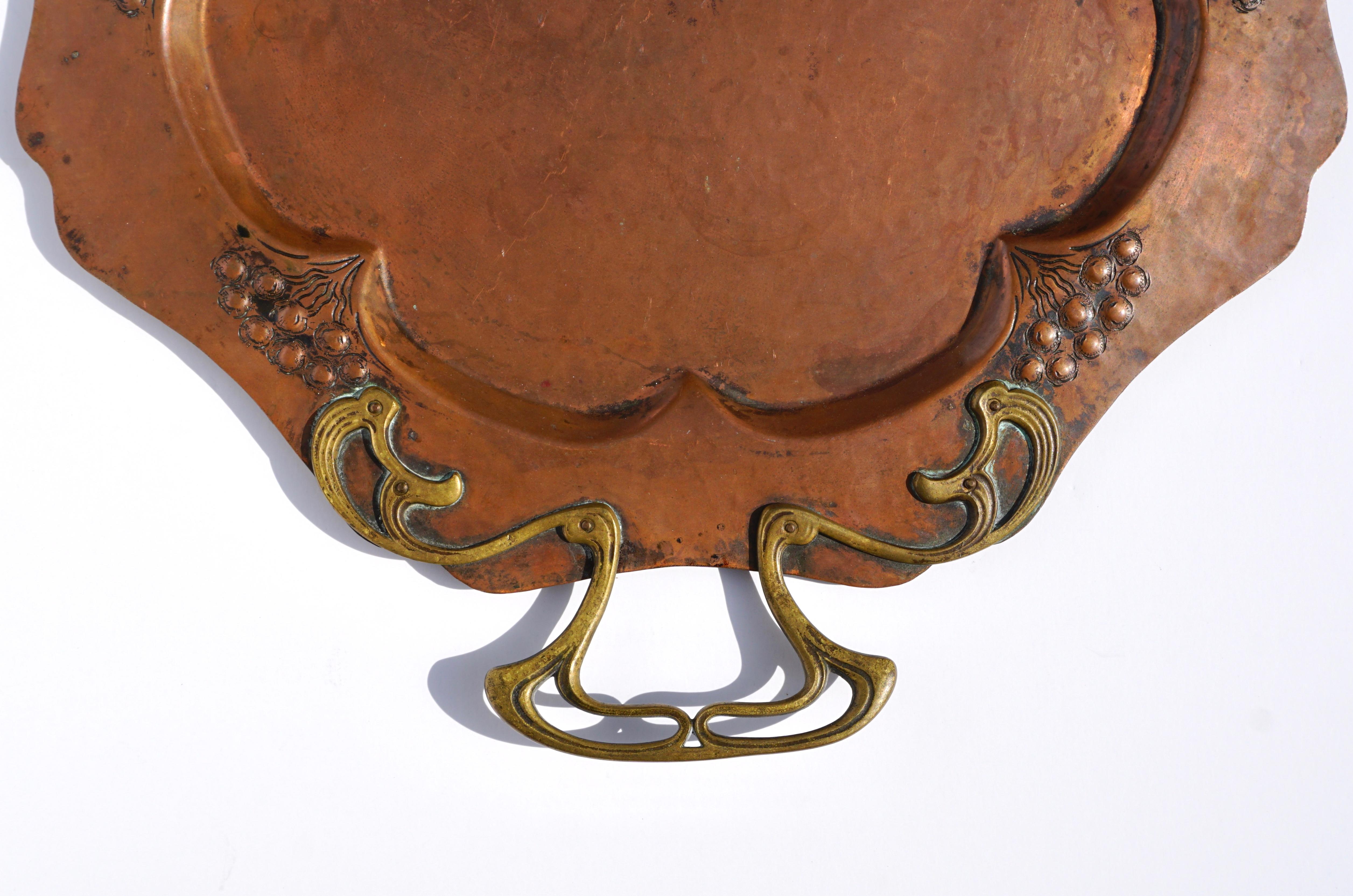 WMF Würtemburgische Machin Fabrik AG
A wonderful Art Nouveau Jugendstil hand-hammered copper and brass serving tray, circa 1905.

Measures: Width 19 inches
Height 15 inches

Ostrich in diamond impressed mark on back.

Condition: Wear commensurate of