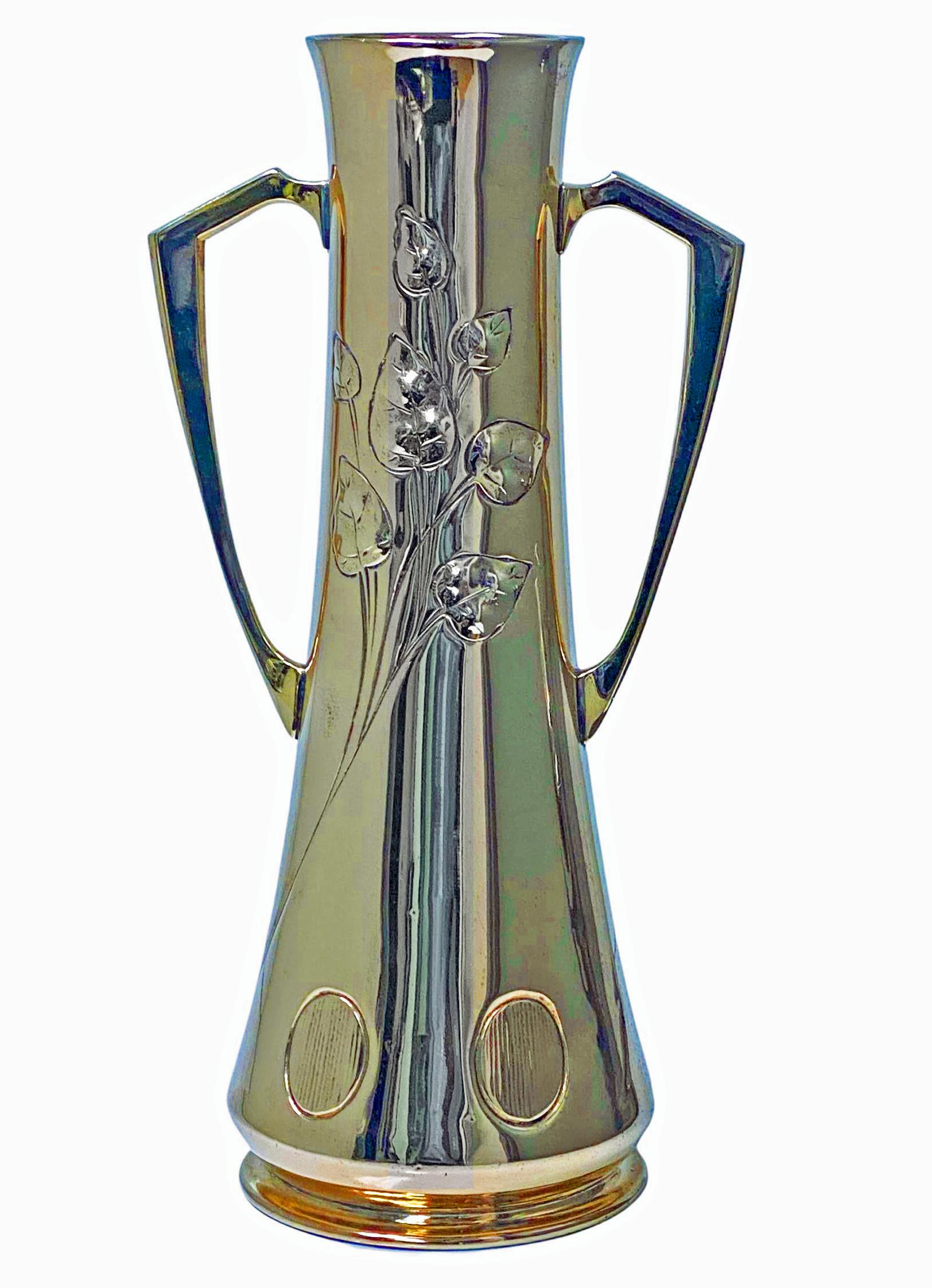 WMF Art Nouveau Jugendstil large Brass Vase Germany C.1910. Two handled secessionist style  Vase of tapered form, stylised embossed foliate and oval textured panels surround to lower body. Beehive mark introduced 1909 under base. Height: 12 inches.