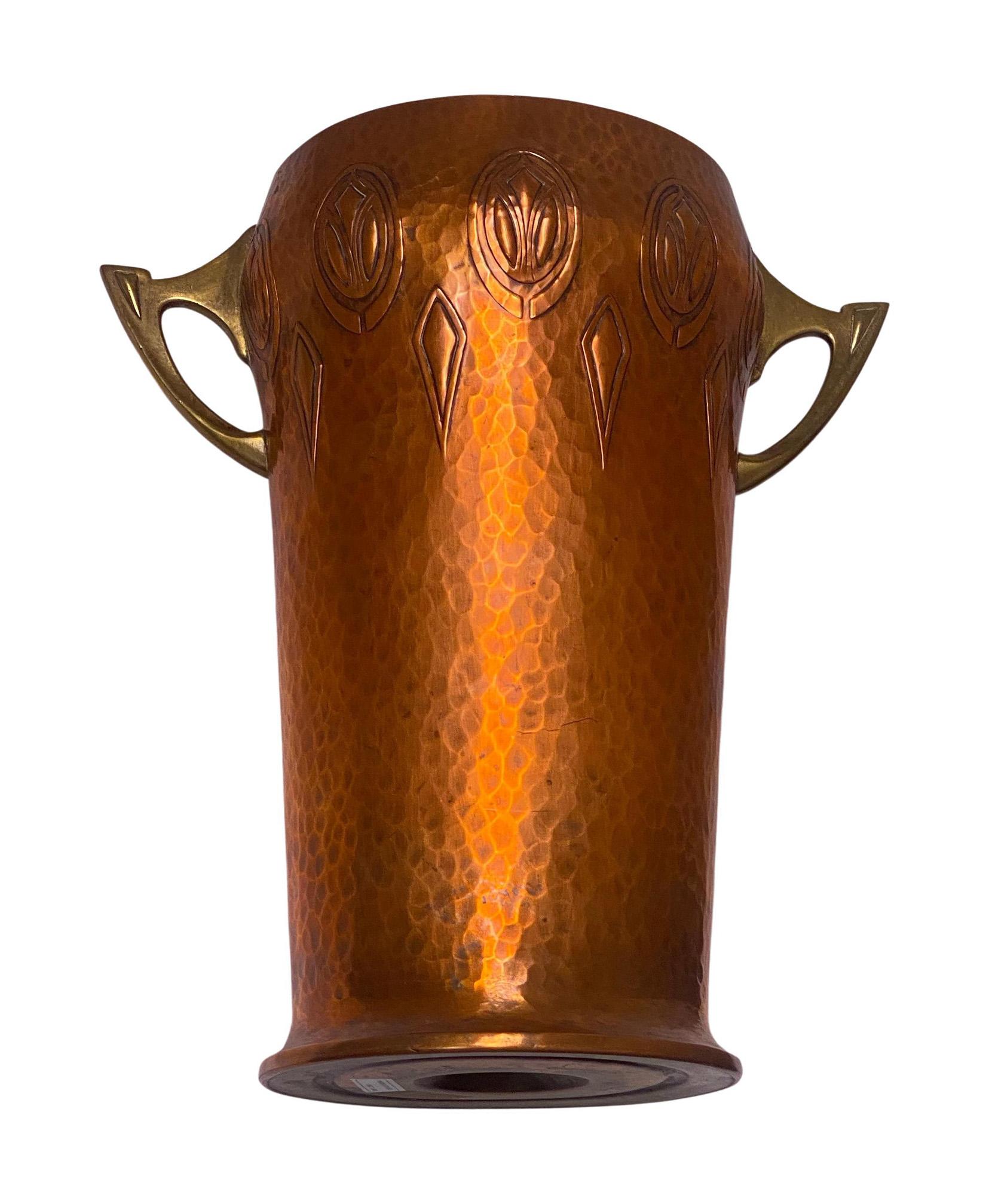 W.M.F Art Nouveau Jugendstil Wine Cooler, Germany C.1900. The hammered copper Cooler of large size, slightly tapered cylindrical form, the top decorated with art nouveau jugendstil panel surround, the brass handles of open art nouveau stylised form.