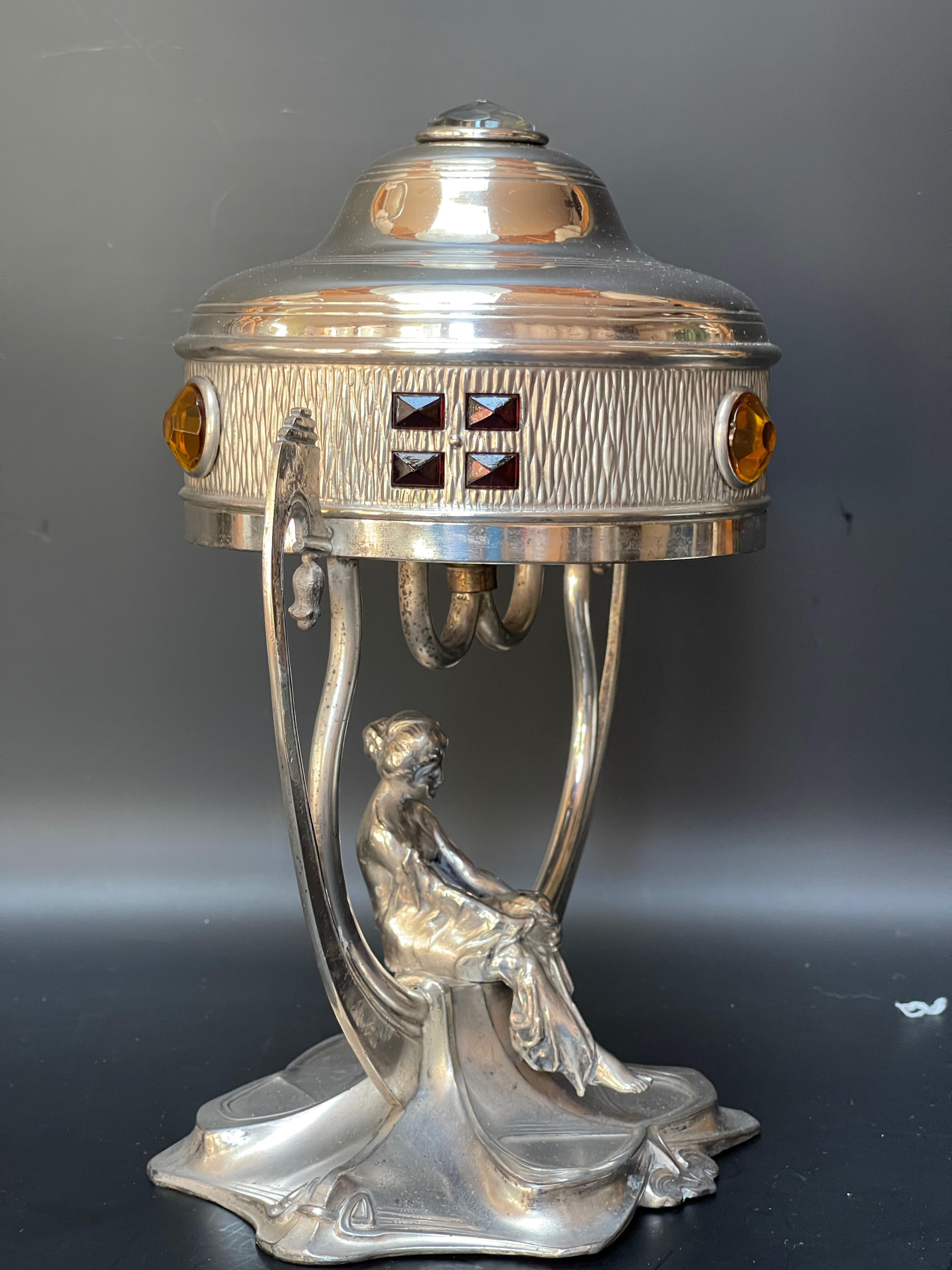 Art Nouveau night light around 1900.
Silver metal and glass cabochons.
Attributed to WMF.
Electrified and in very good condition

Width: 17 cm
Height: 28 cm
Depth: 14,5 cm
Weight: 1,3 Kg

WMF was originally called Metallwarenfabrik Straub