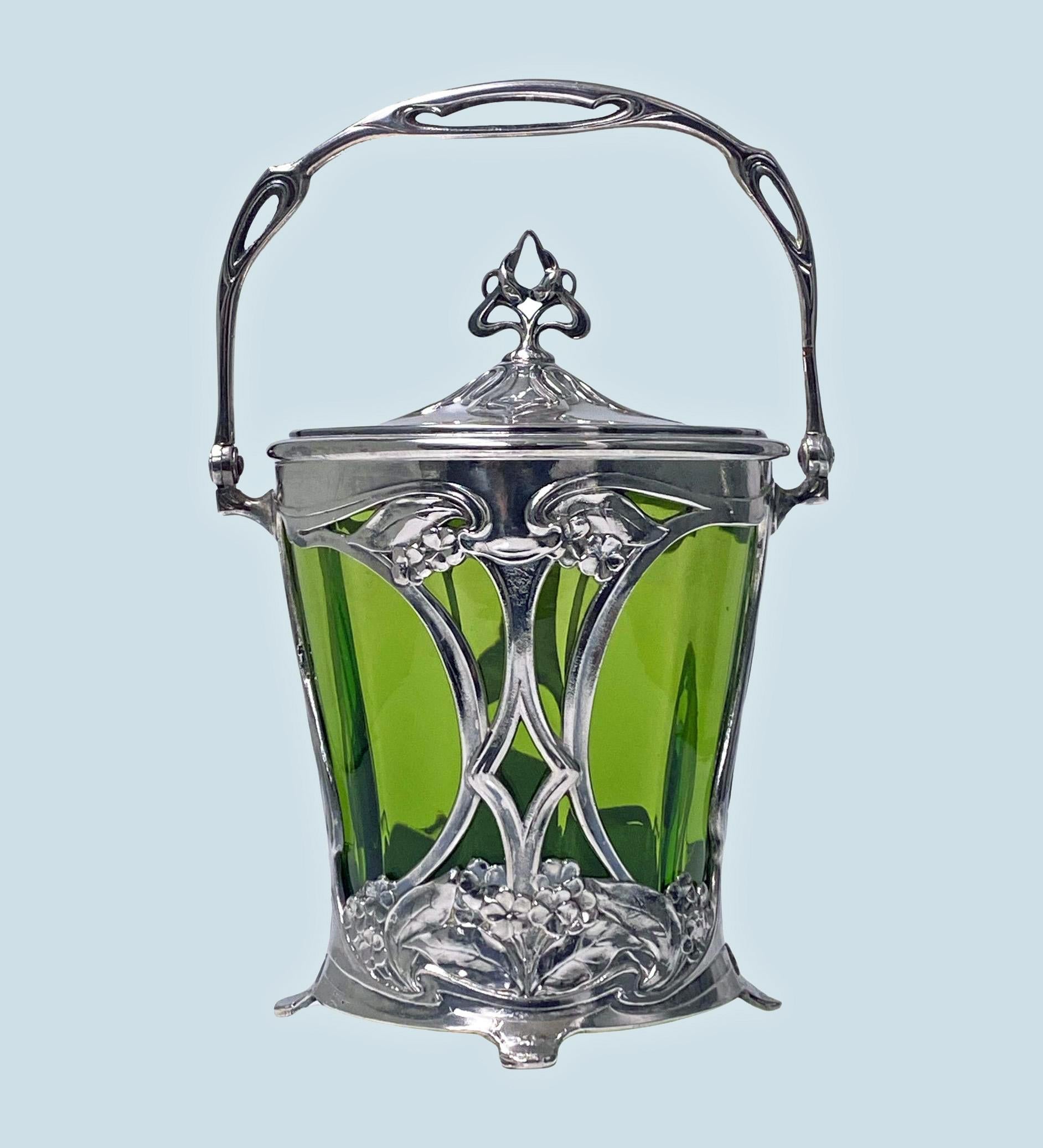 WMF Jugendstil Art Nouveau silver on pewter and glass Biscuit Box. Stamped marks running ostrich B I/0 OX and 231. Illustrated WMF 1906 Catalogue page 251 model number 231. Circa 1906. Original green paneled glass liner, the silvered pewter of