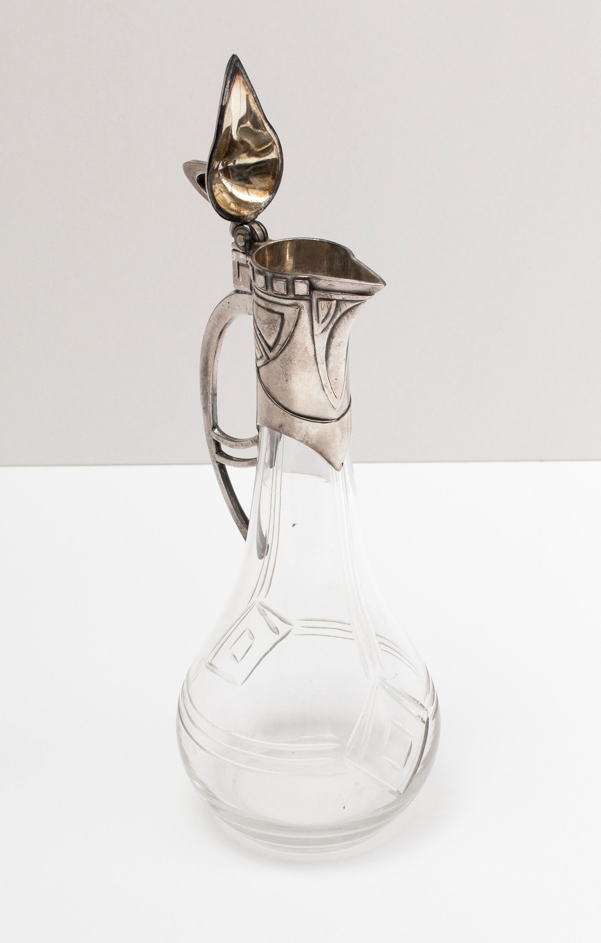 Beautiful little WMF pitcher from the Art Nouveau period with beautiful patina and original glass.