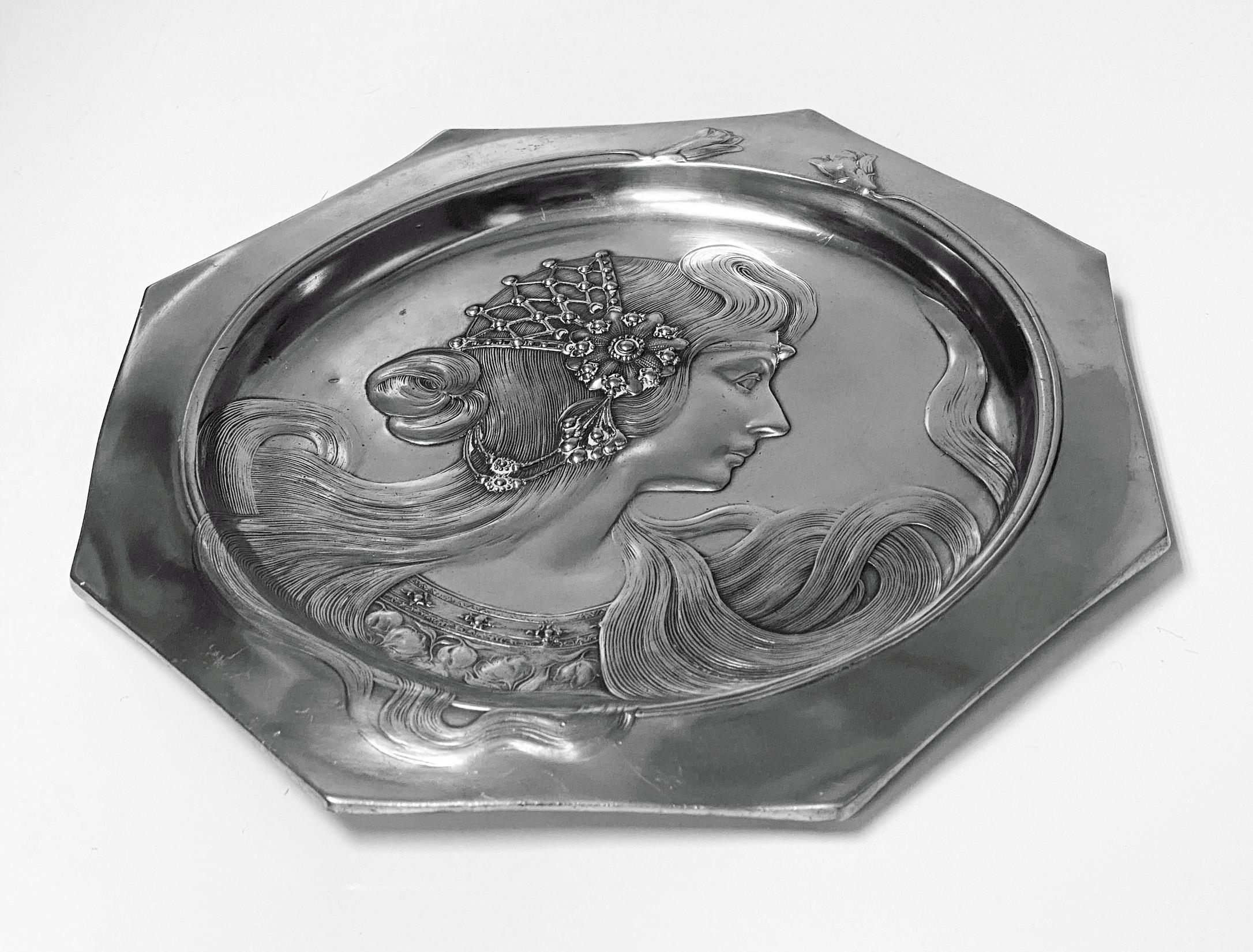 An Art Nouveau Continental Pewter visiting card tray made in Germany circa 1900 by WMF. The octagonal shaped Tray with a circular centre with a female head with long flowing bejewelled hair. Marked on the reverse within a small oval punch 