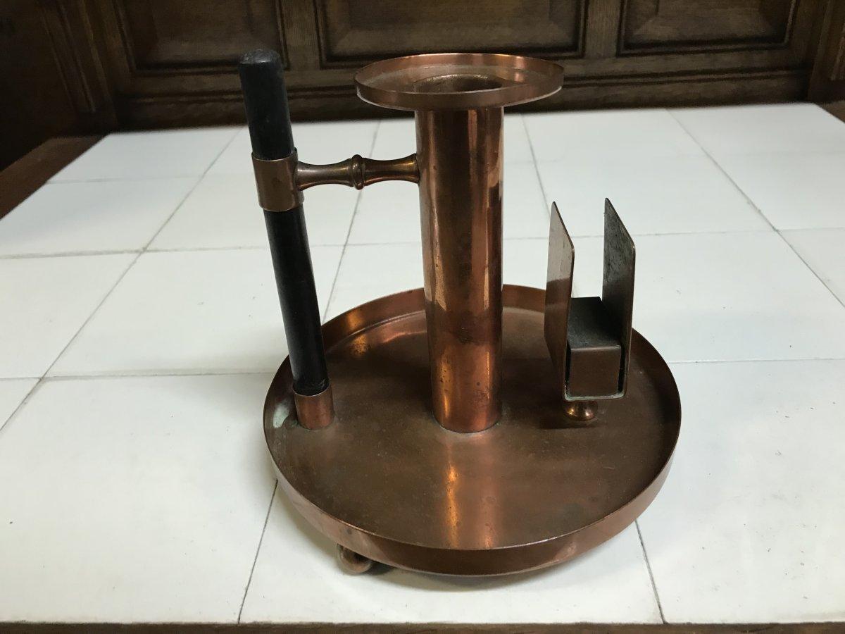 WMF. An Aesthetic Movement Copper Chamber Candlestick and match book holder in the Dr C Dresser Style.