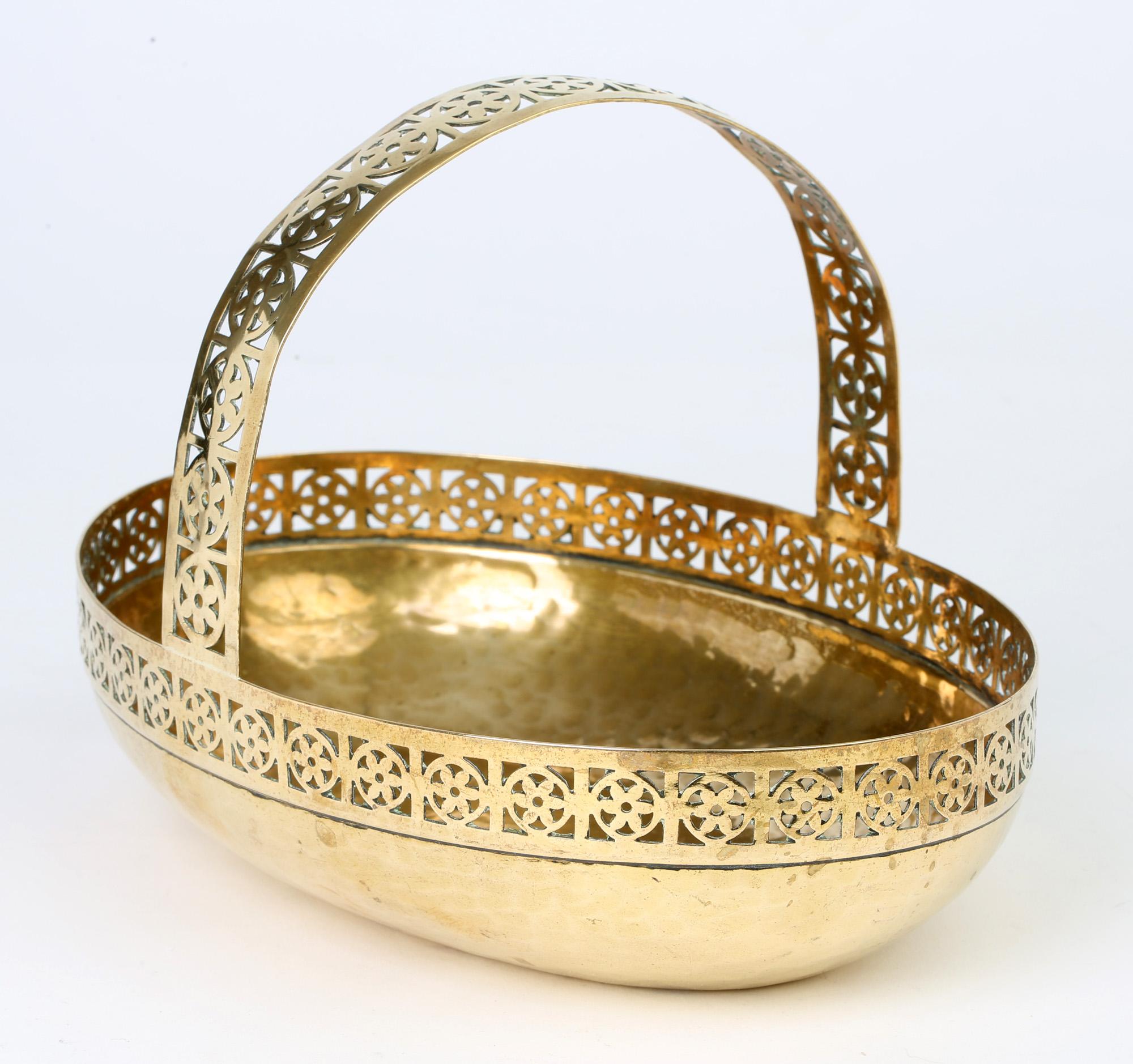 A very stylish German Jugendstil planished brass bread basket in the manner of Josef Hoffmann by WMF (Württembergische Metallwarenfabrik) and dating from circa 1910. The basket is of oval shape with a hammered body below a pierced rim with roundel