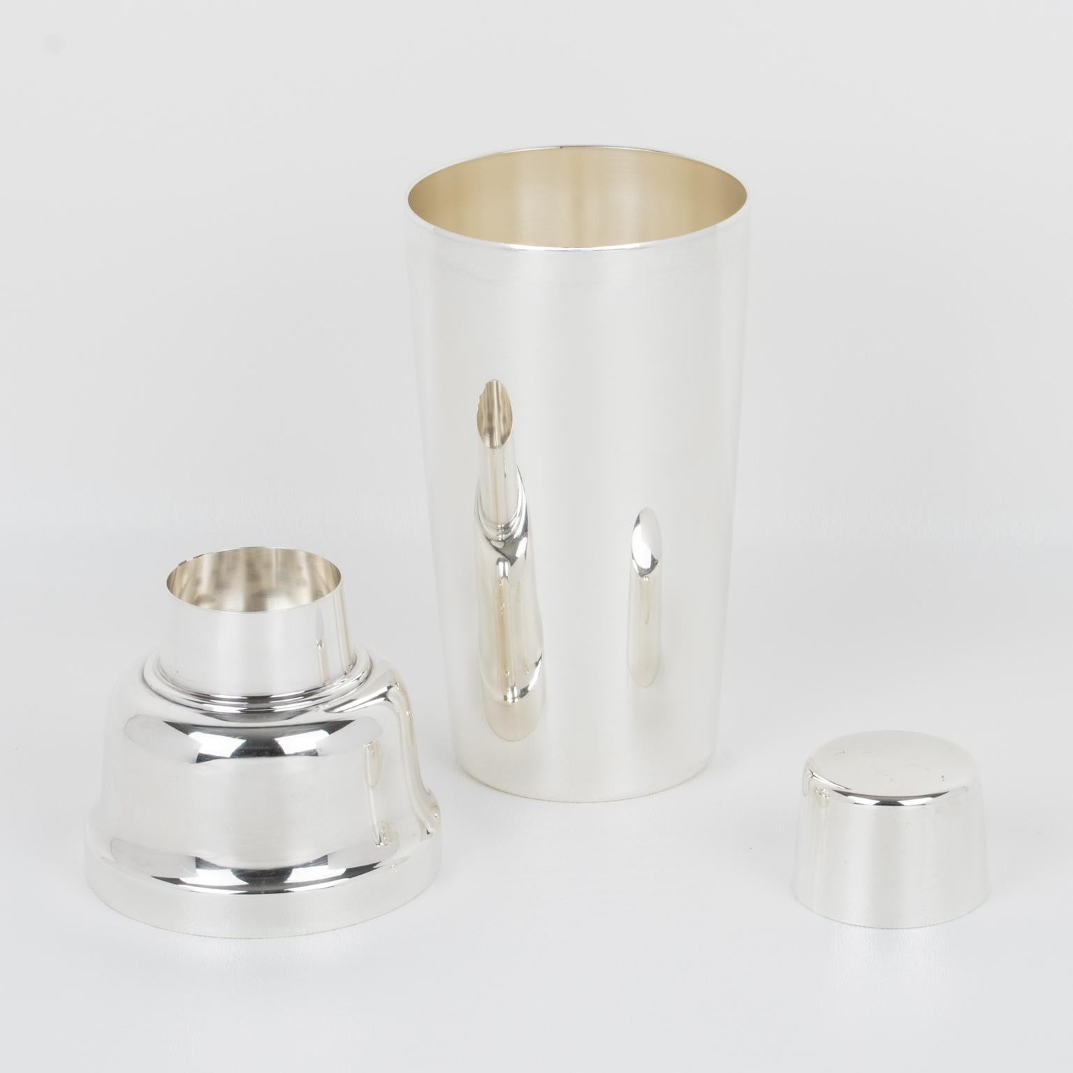 This fabulous Art Deco silver plate cylindrical cocktail or Martini shaker was crafted by silversmith WMF, Germany, in the 1920s. The three-sectioned cocktail shaker has a removable cap and strainer. The lovely geometric shape boasts a typical