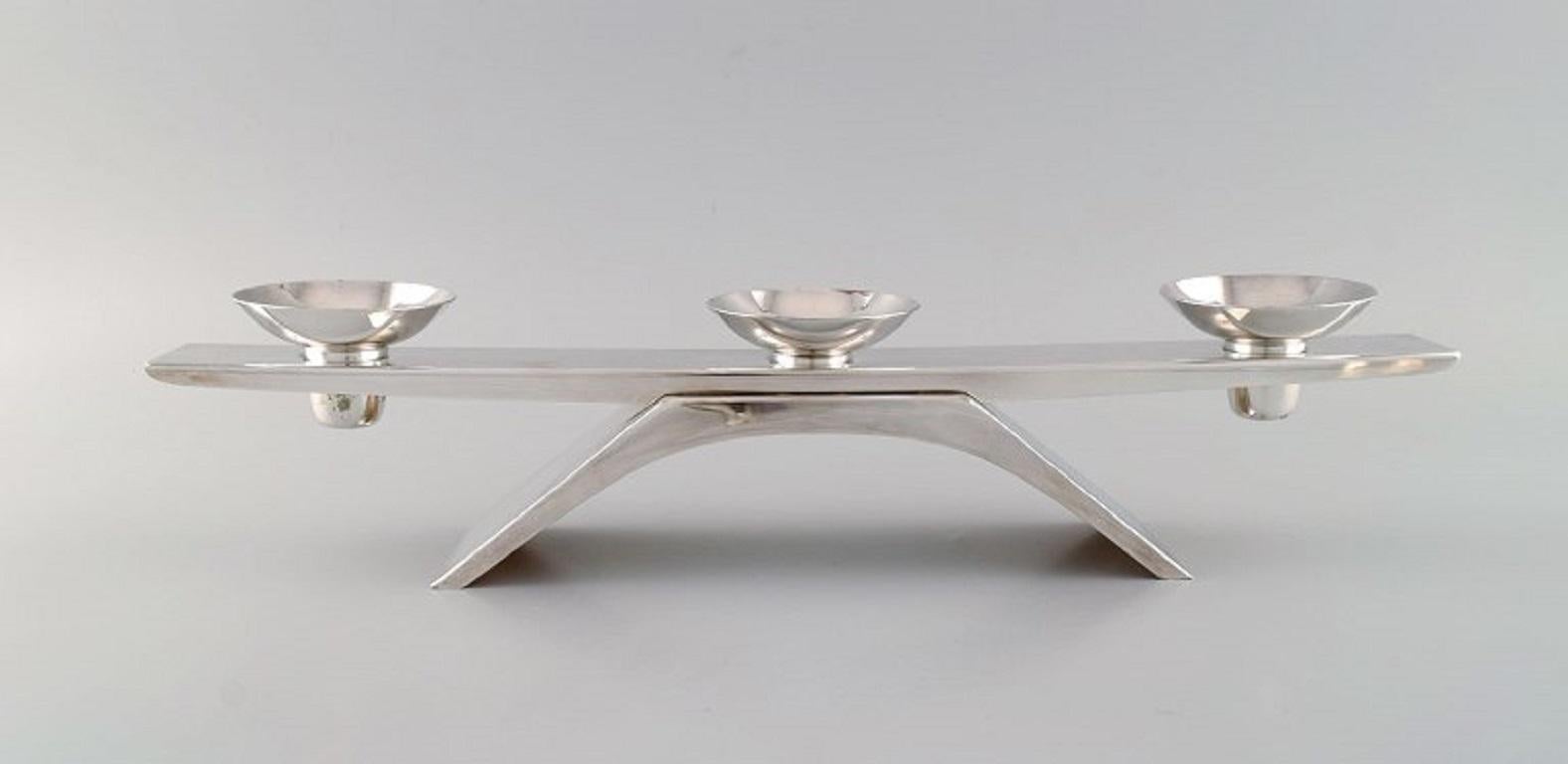 WMF, Germany. Modernist Ikora candleholder in plated silver. 
Mid-20th century.
Measures: 41.5 x 6.5 cm.
Height: 9 cm.
In excellent condition.
Stamped.