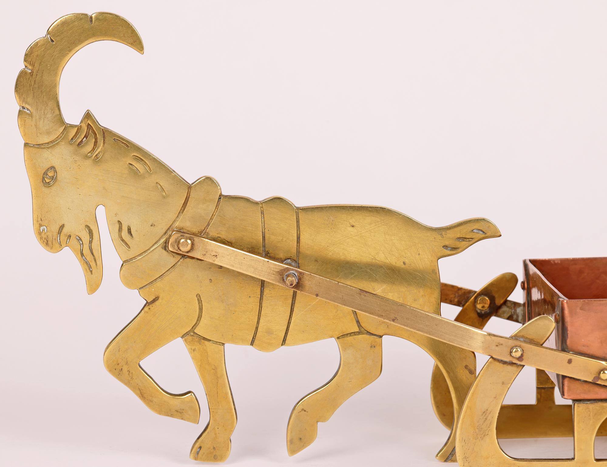 A rare and unusual German Jugendstil copper and brass smokers companion or candleholder formed as a goat pulling a sleigh the design attributed to renowned sculptor Ignatius Taschner (German, 1871-1913) for WMF (Württembergische Metallwarenfabrik)
