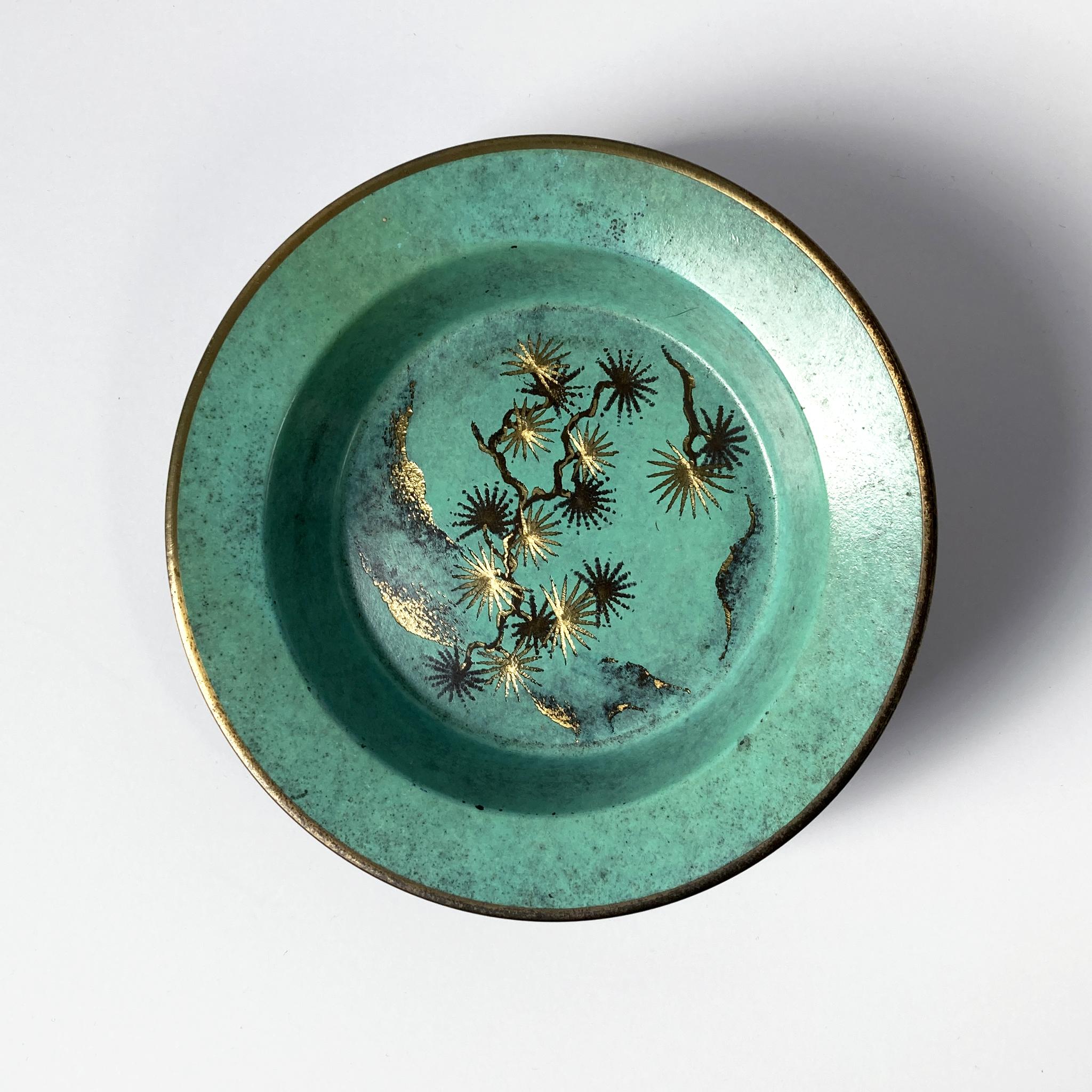 Rare Paul Haustein, WMF Ikora metal vide poche with glass insert. The patinated green metal contrasts beautifully with the etched gold and dark brown pattern seen on the dish. The glass insert has beautifully bevelled edges and fits the metal dish